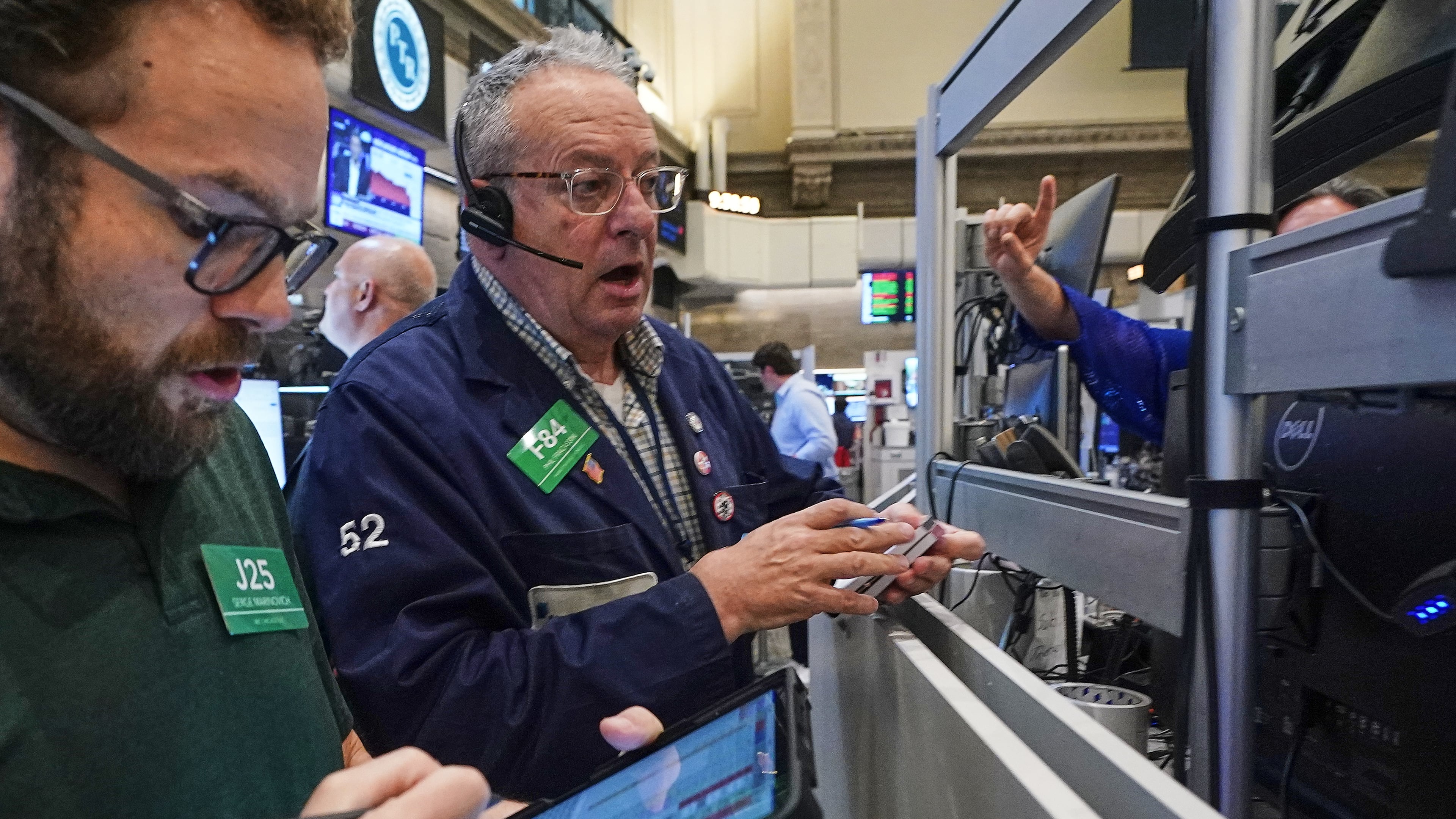 Options traders Serge Marinovich, left, and Phil Phil Fracassini work on the floor of the New York Stock Exchange, Friday, June 26, 2026. (AP Photo/Richard Drew)