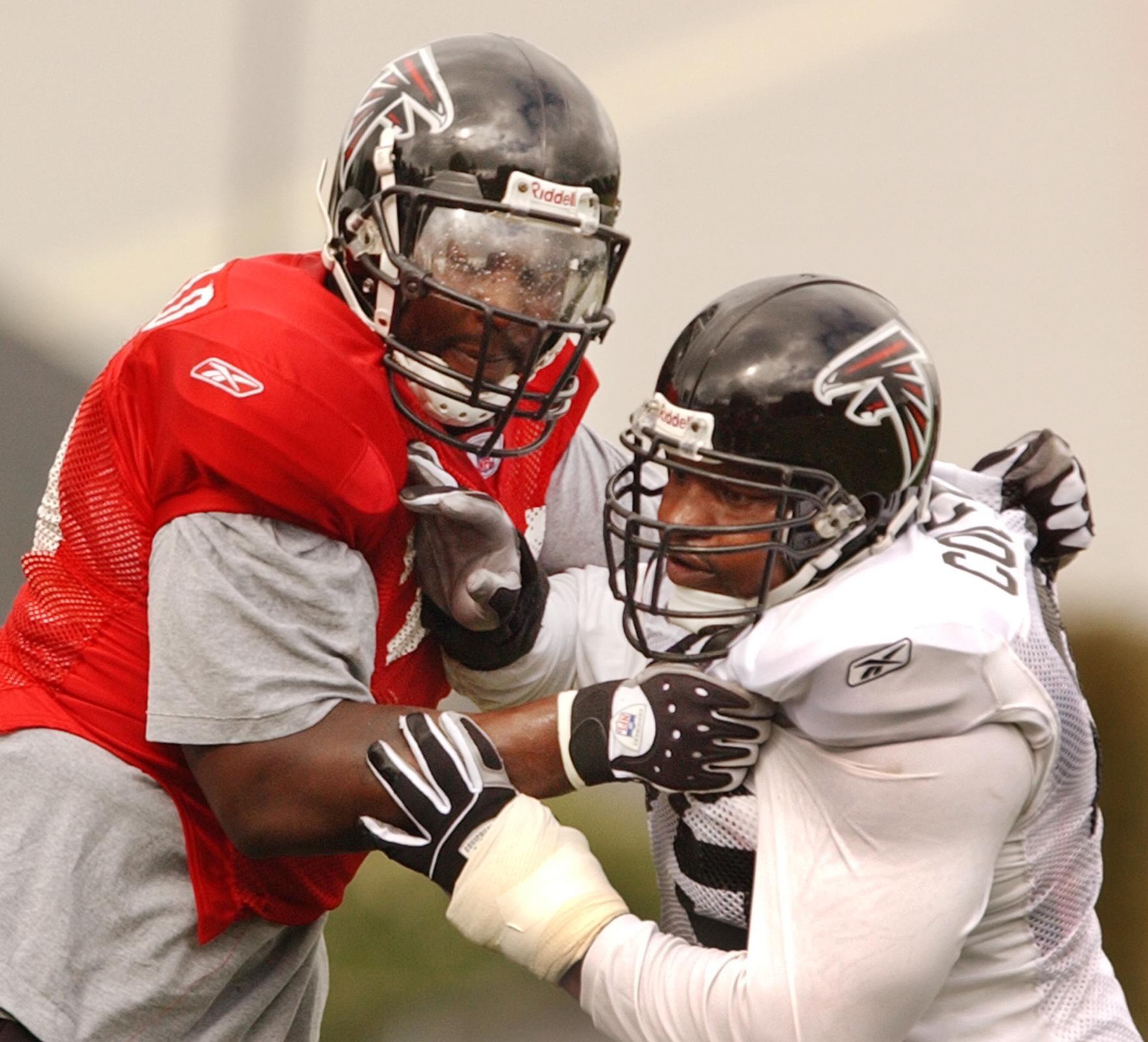 Falcons tackle Bob Whitfield (left) blocks teammate Rod Coleman during practice in 2004. (CURTIS COMPTON/AJC staff)