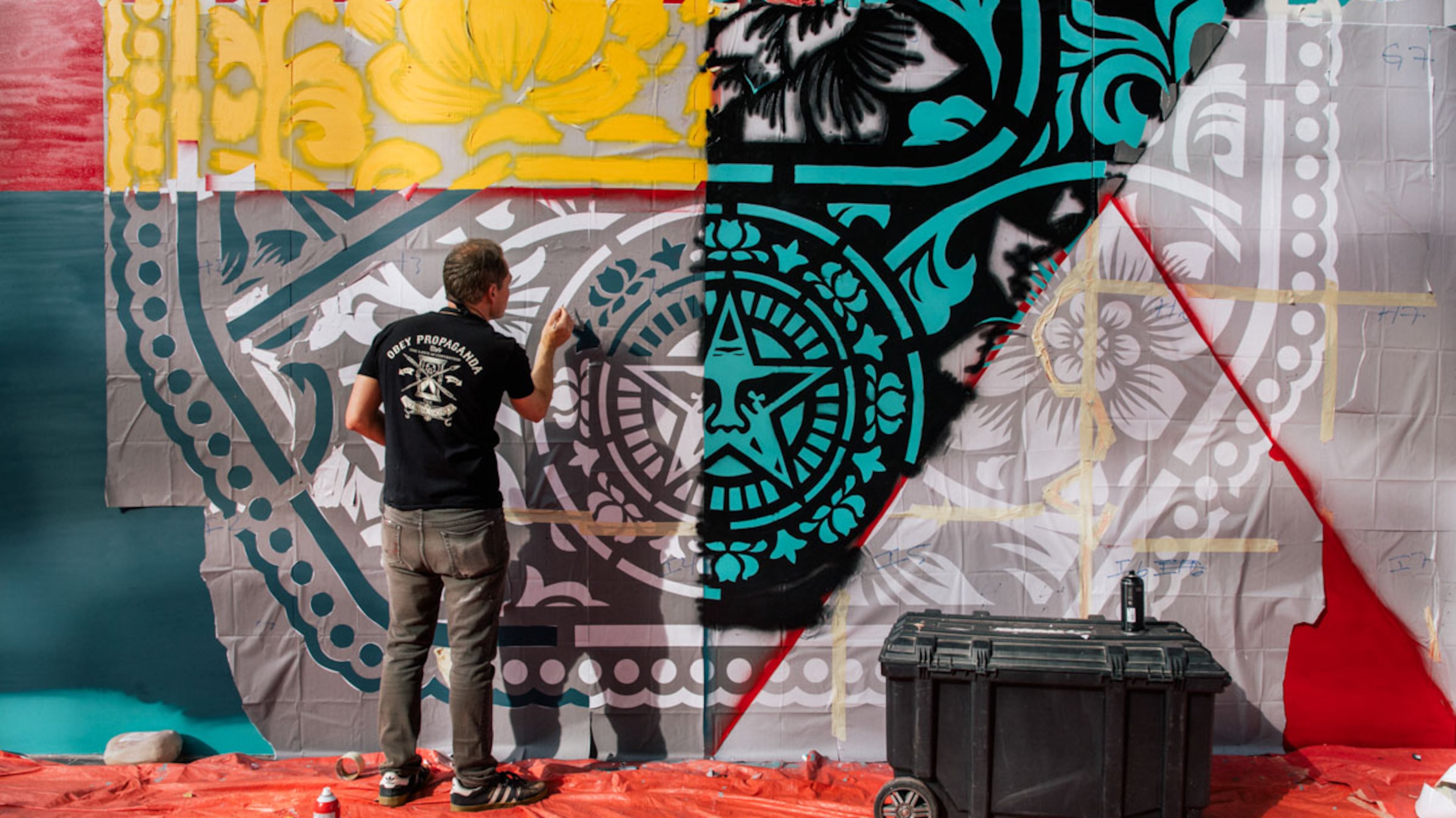 Fairey works on a mural. An exhibition of his work is currently on at the ABV Gallery in Atlanta. (Courtesy of ABV Gallery)