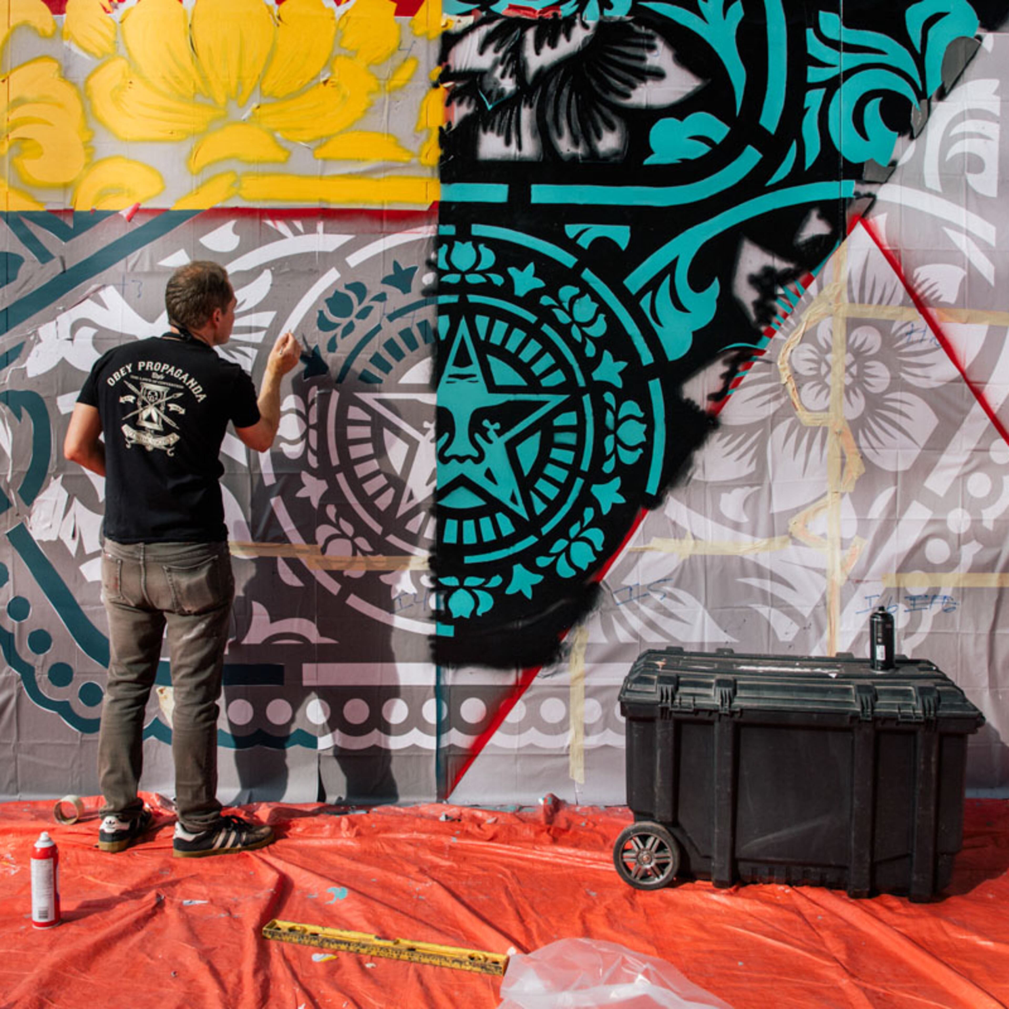 Fairey works on a mural. An exhibition of his work is currently on at the ABV Gallery in Atlanta. (Courtesy of ABV Gallery)