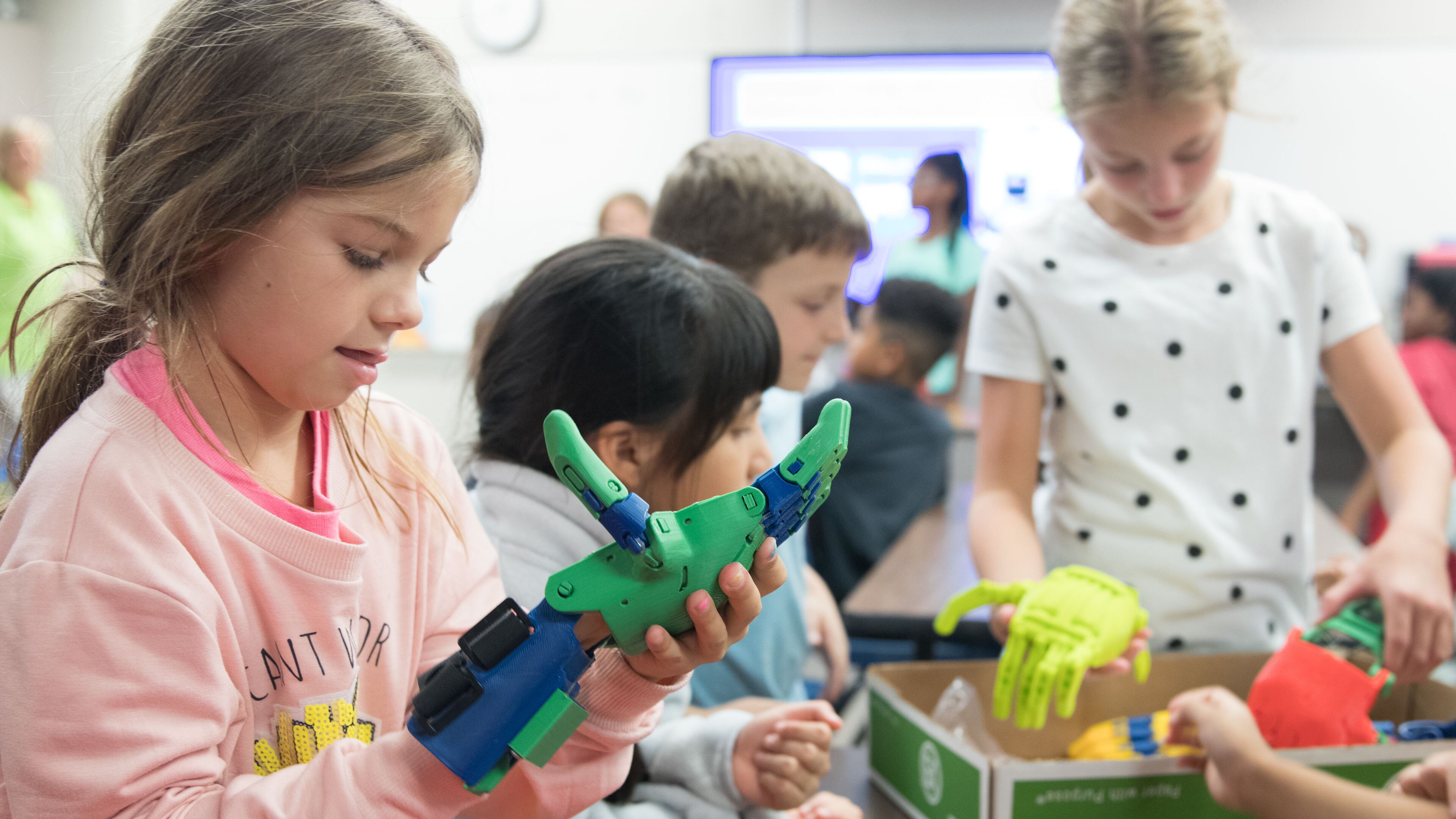 A Blackwell Elementary School student tries on the robotic arm.