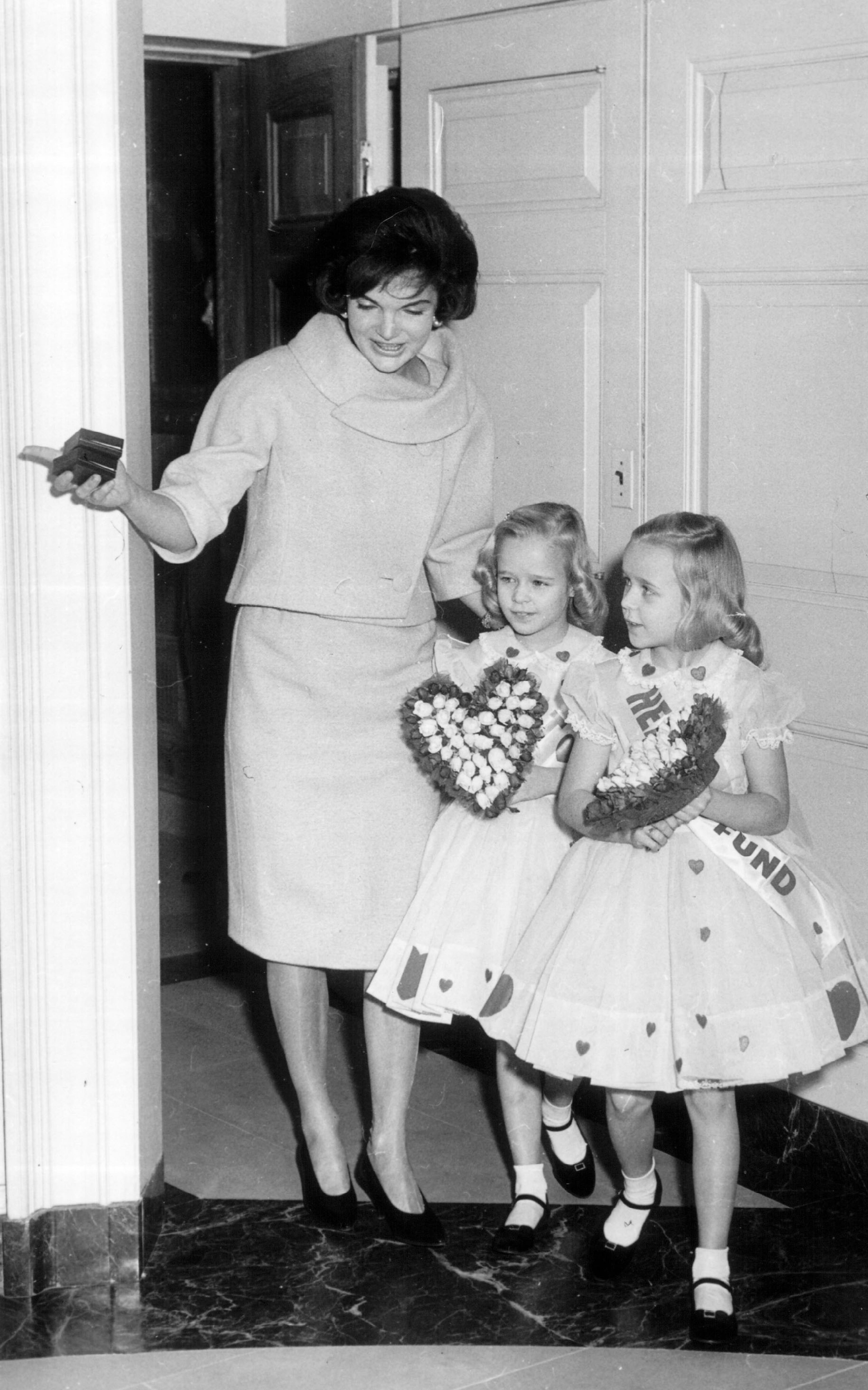 First Lady Jacqueline Kennedy walks with two young girls at the White House. (Courtesy of National Archive/Newsmakers)