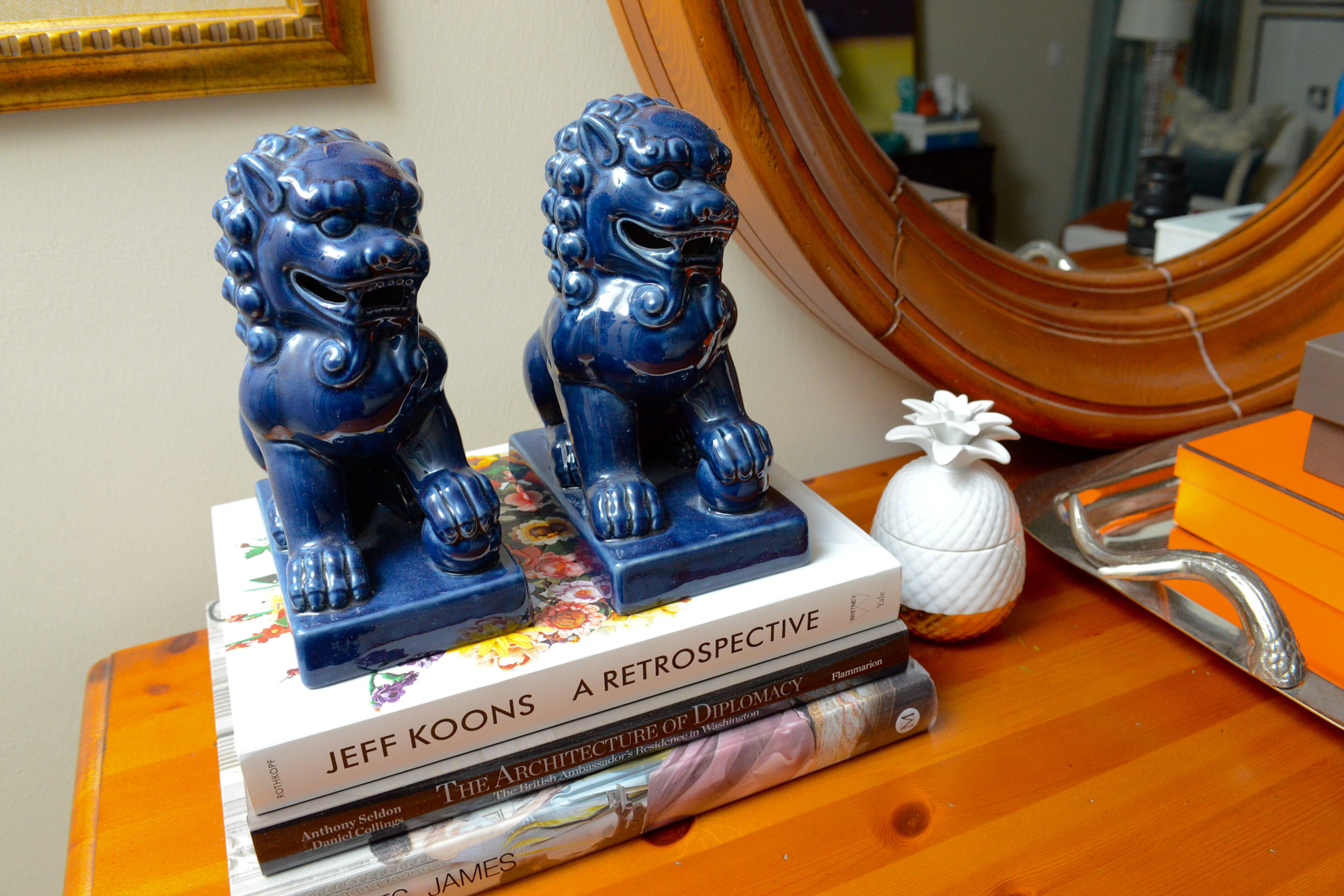 Chinese foo dog statues sit atop a collection of architecture, art and design books in the master bedroom of the Union City home.