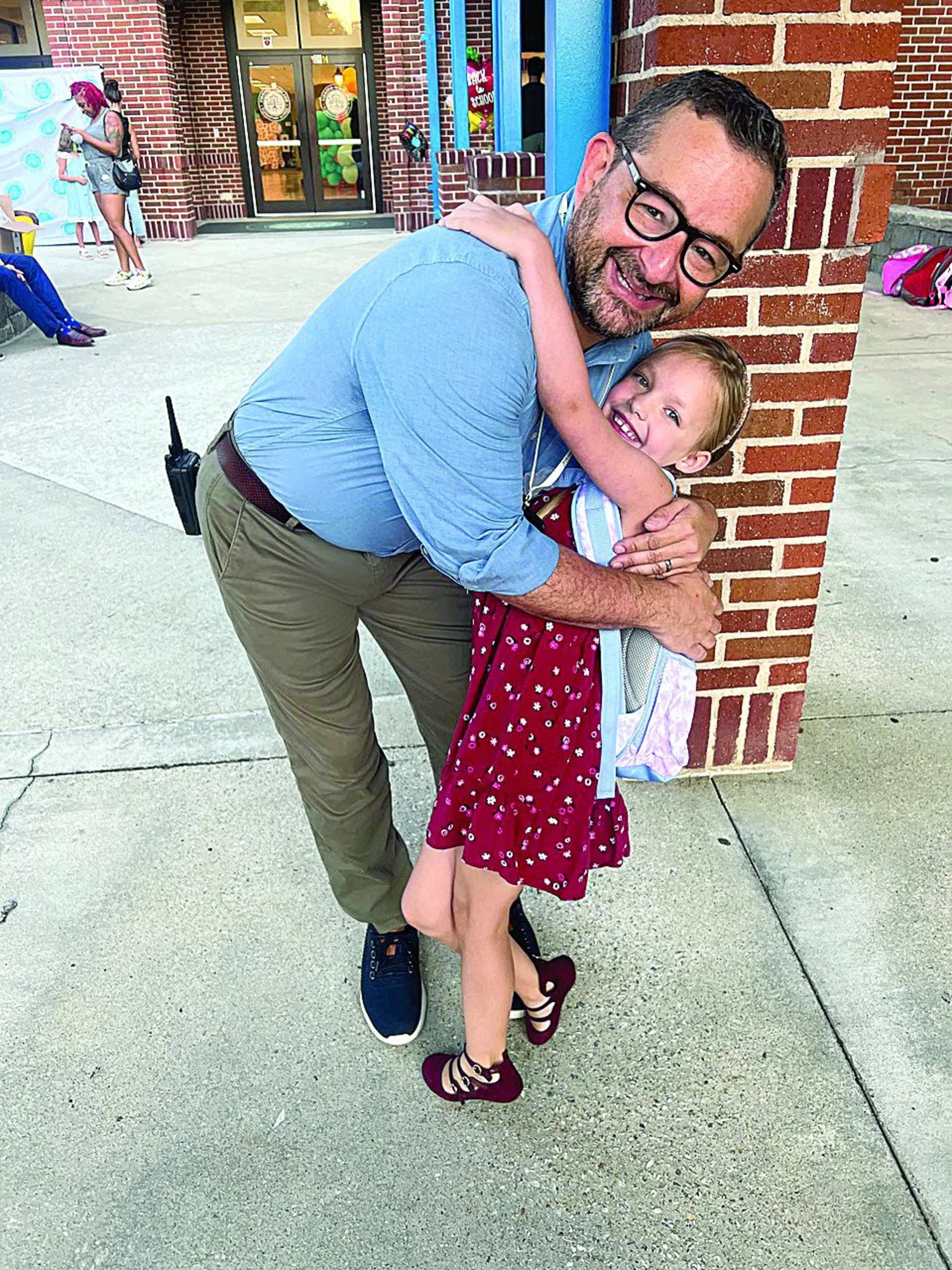 First grade student Quinn Clark hugs Principal Terry Harness (Photo Courtesy of Melissa Clark)