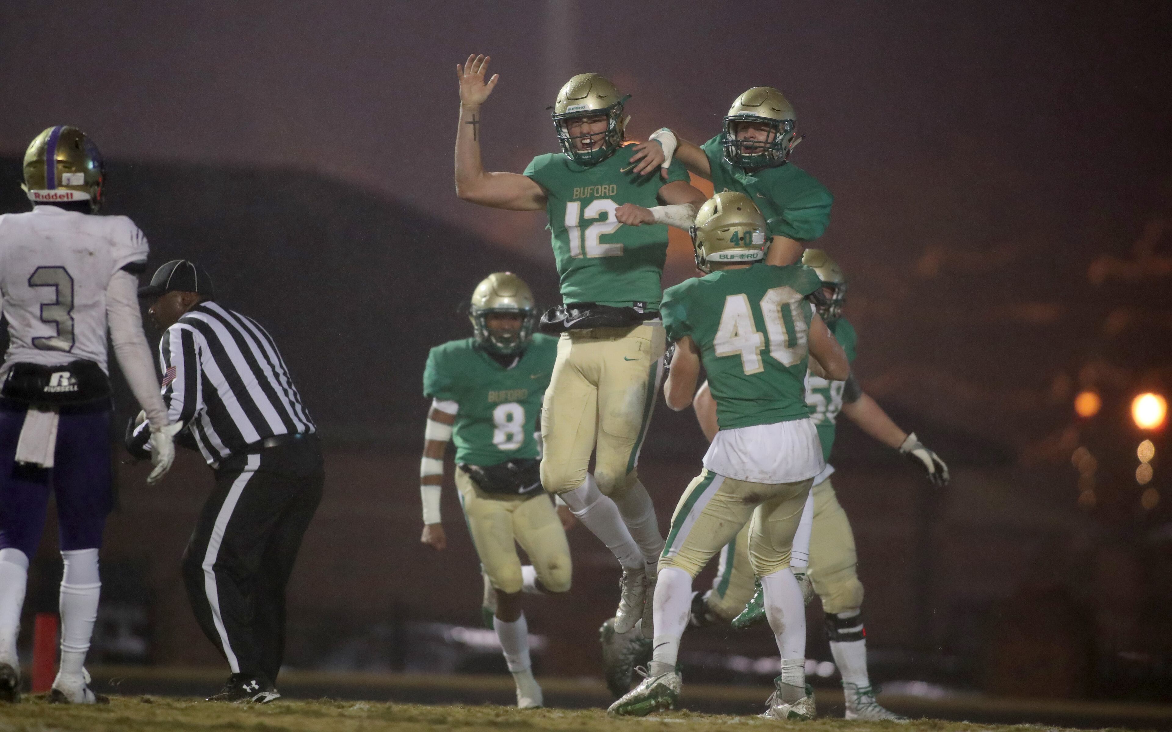 November 23, 2018 - Buford, Ga: Buford quarterback Aaron McLaughlin (12) celebrates his rushing touchdown in the first half against Bainbridge at Buford High School Friday, November 23, 2018, in Buford, Ga. This is the quarter finals of the Class 5A state playoffs. (JASON GETZ/SPECIAL TO THE AJC)