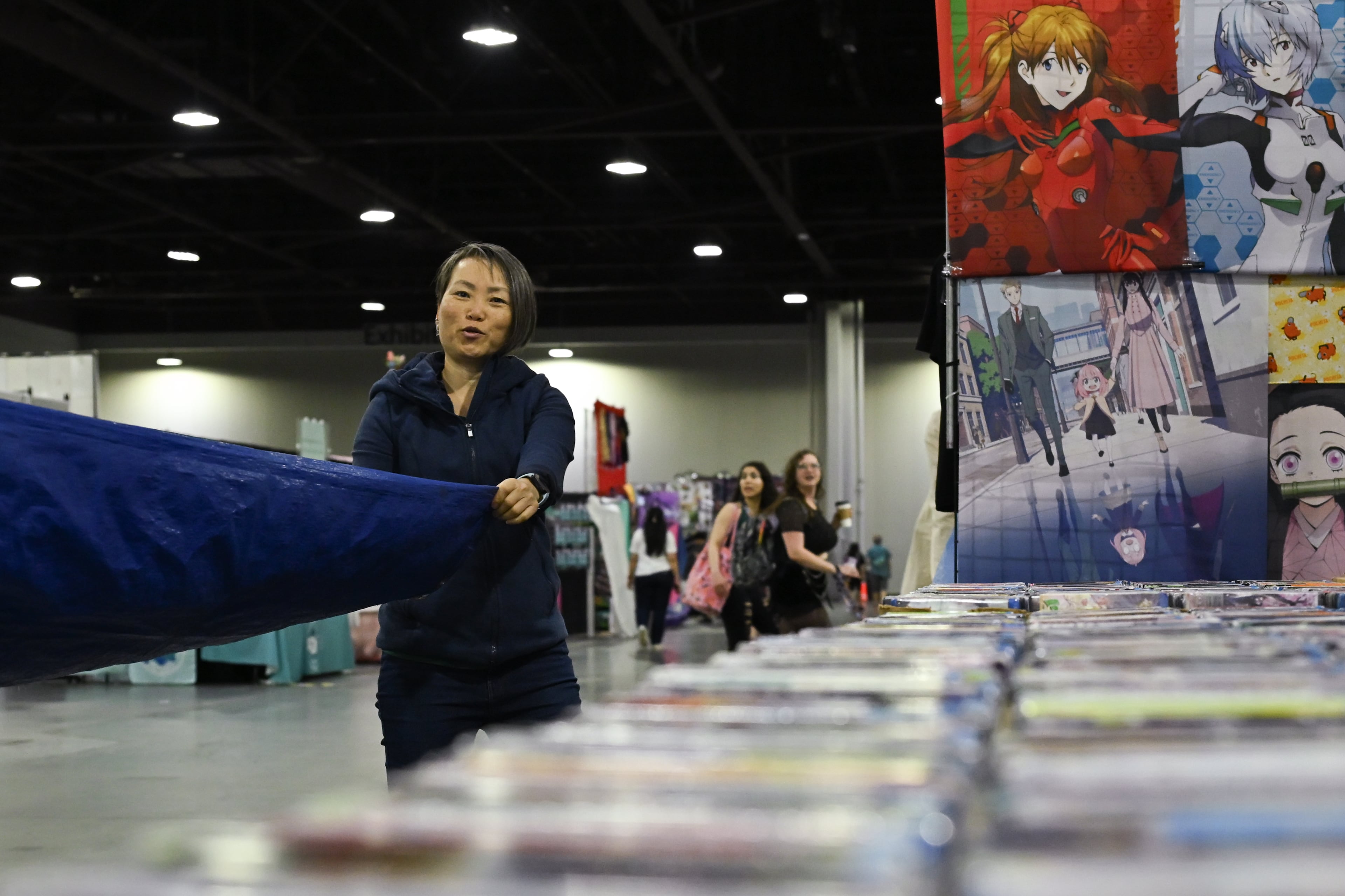 A vendor prepares her booth during MomoCon at the Georgia World Congress Center in Atlanta on Friday, May 22, 2026. Organizers expect over 60,000 attendees. (Tyler Sun for the AJC)