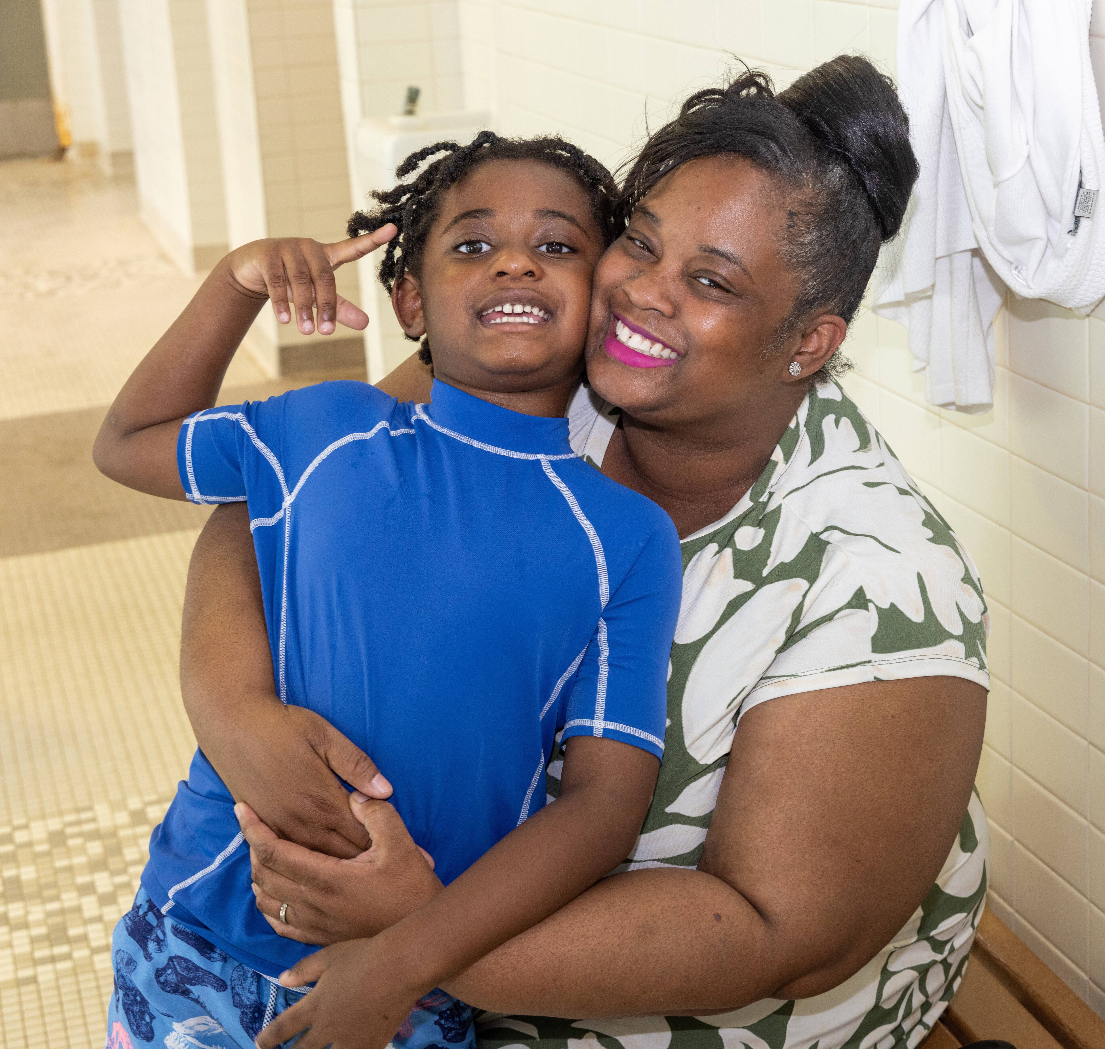 Cassandra Davis (right) said her 4-year-old son Lewis had speech delays, but he said some of his first words during adaptive swim lessons with his instructor, Lillian Thompson, at the Decatur YMCA. (Phil Skinner for the AJC)