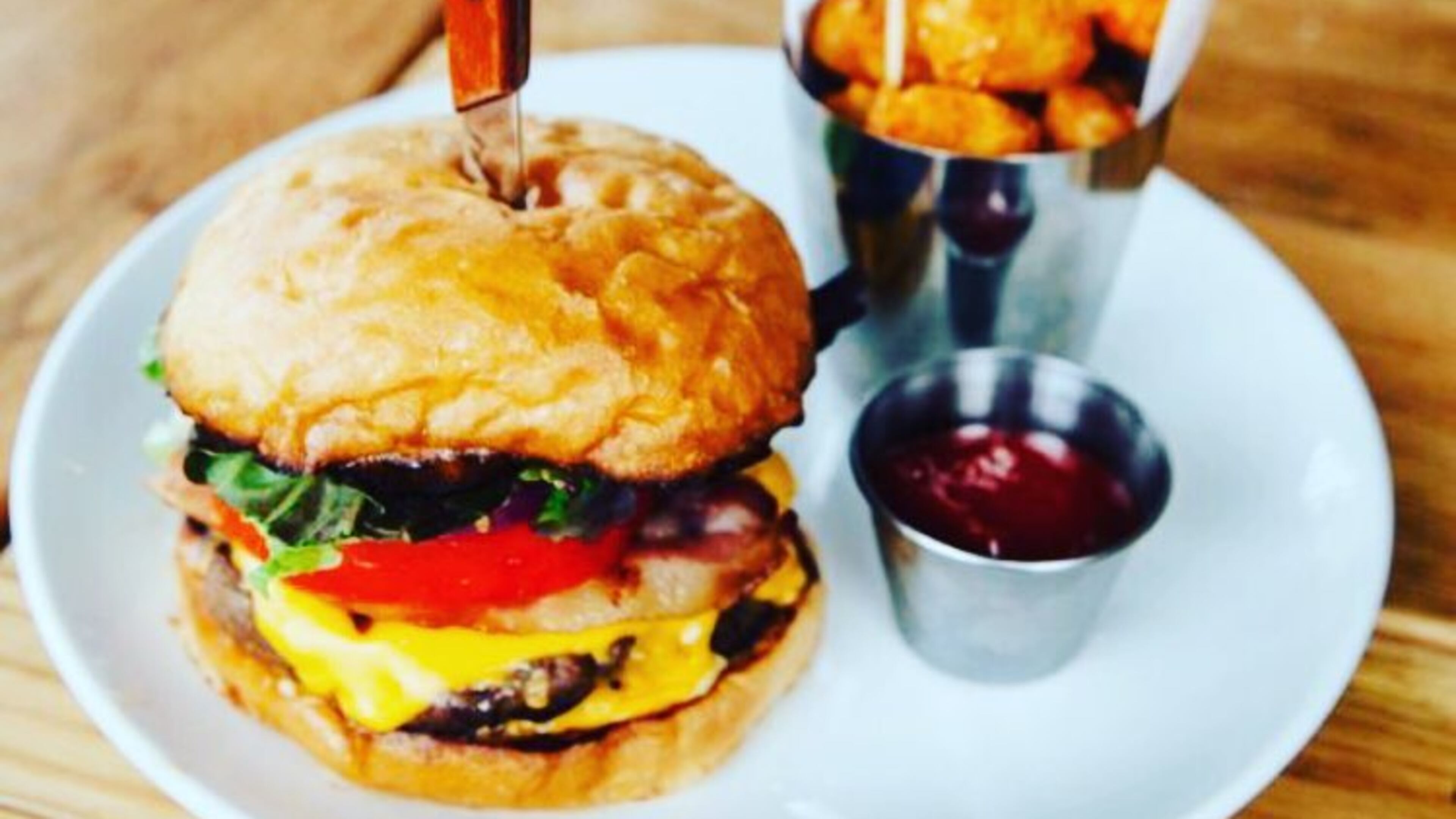 Bite into a $5 burger at The Pinewood. Photo credit: The Pinewood's Facebook.