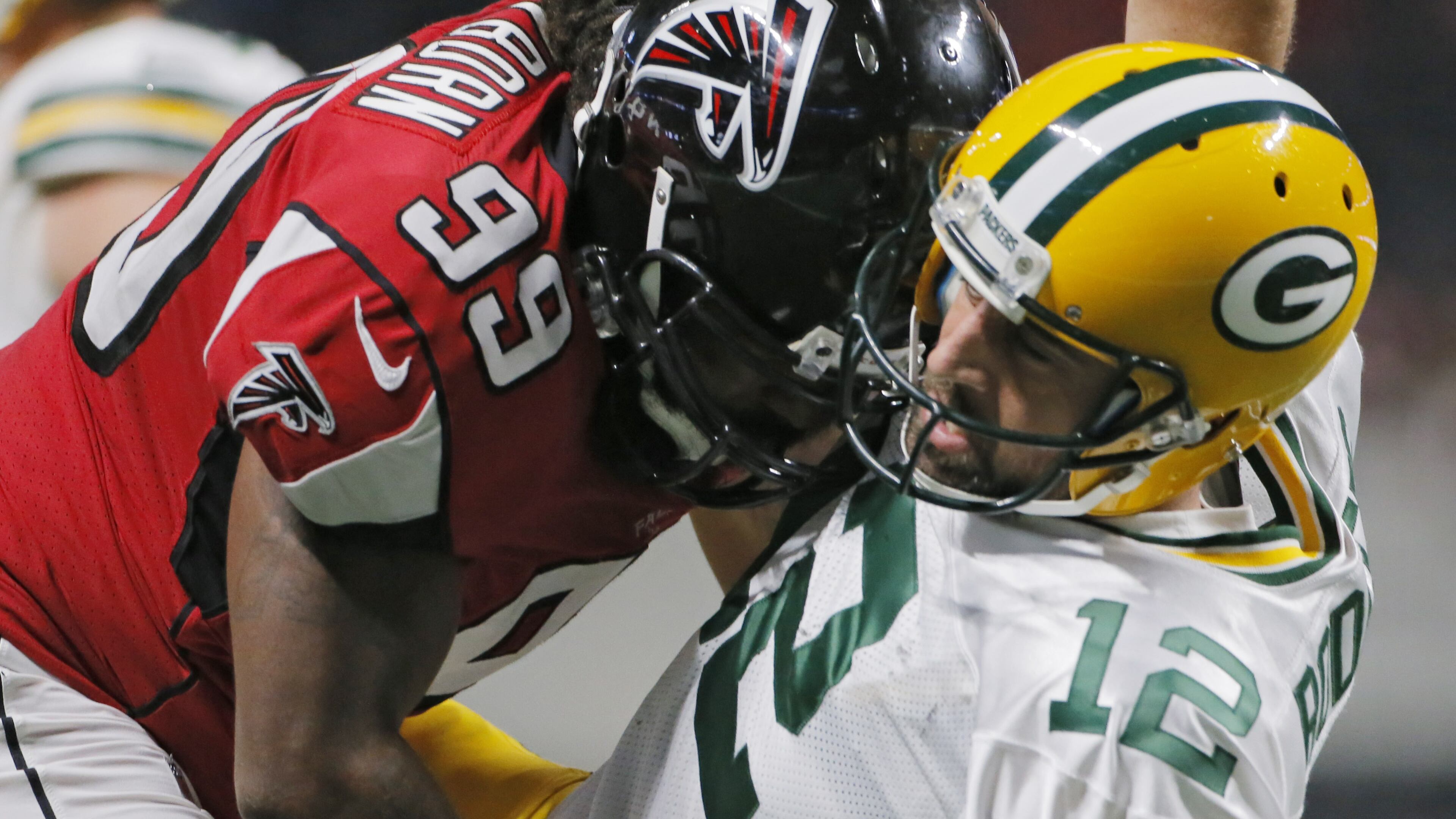 9/17/17 - Atlanta, GA - Atlanta Falcons defensive end Adrian Clayborn hits Green Bay Packers quarterback Aaron Rodgers as he throws. Atlanta Falcons vs Green Bay Packers. The Falcons opened the roof for the Falcons season opener at Mecedes-Benz Stadium. BOB ANDRES /BANDRES@AJC.COM