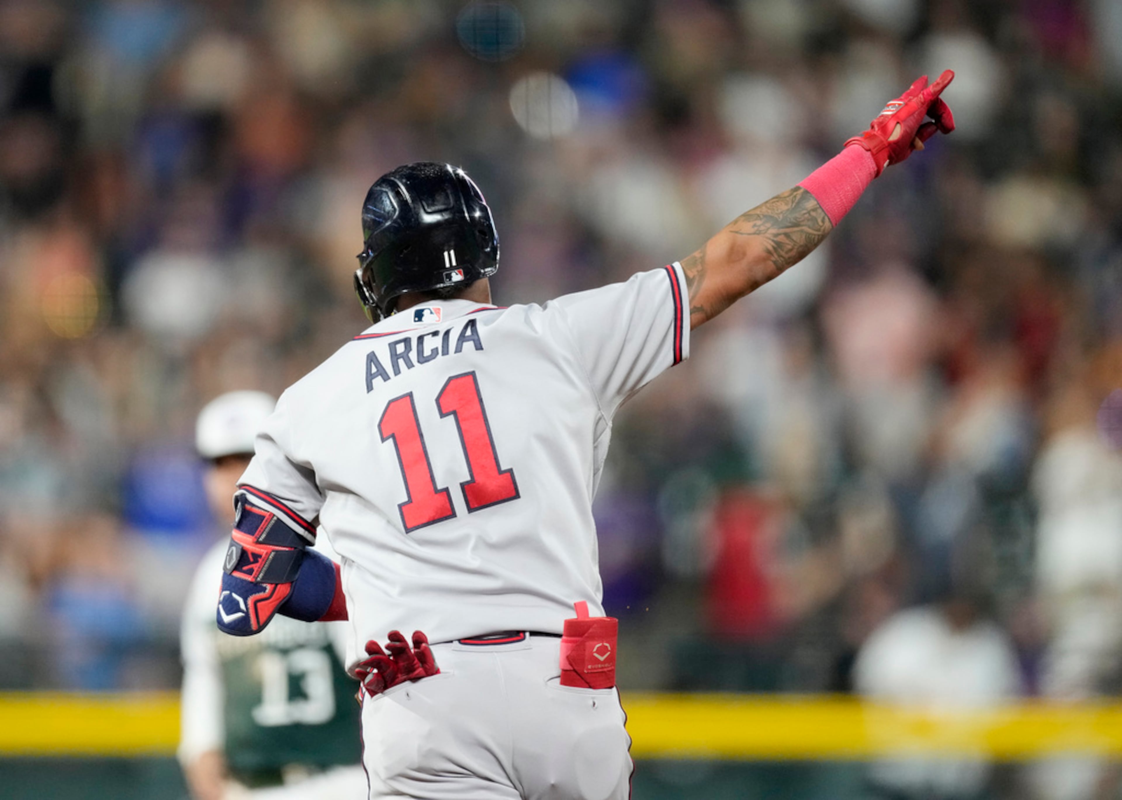 Atlanta Braves' Orlando Arcia gestures as he circles the bases after hitting a two-run home run off Colorado Rockies starting pitcher Kyle Freeland in the sixth inning of a baseball game Wednesday, Aug. 30, 2023, in Denver. (AP Photo/David Zalubowski)
