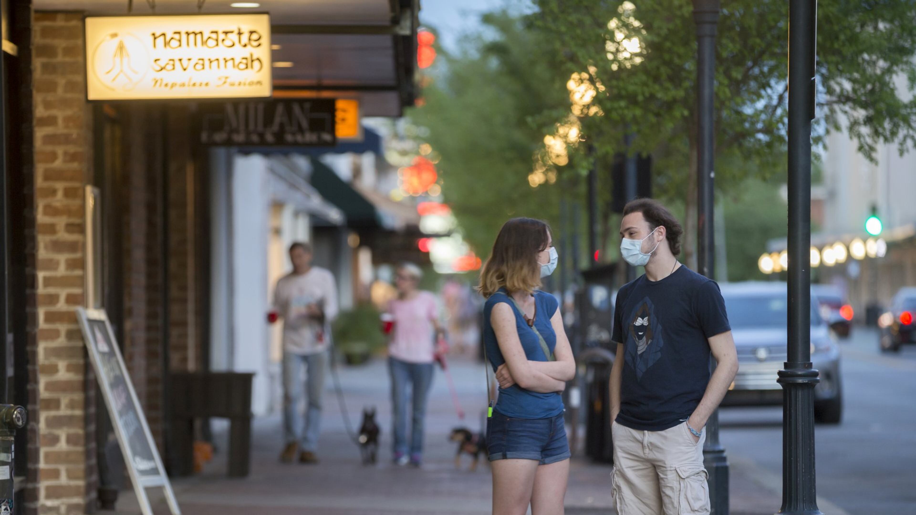 In this file photo, two Savannah College of Art and Design students wearing maks wait for their to-go order at a local restaurant on Broughton Street in the Historic Downtown Neighborhood in Savannah.STEPHEN B. MORTON FOR THE ATLANTA JOURNAL-CONSTITUTION