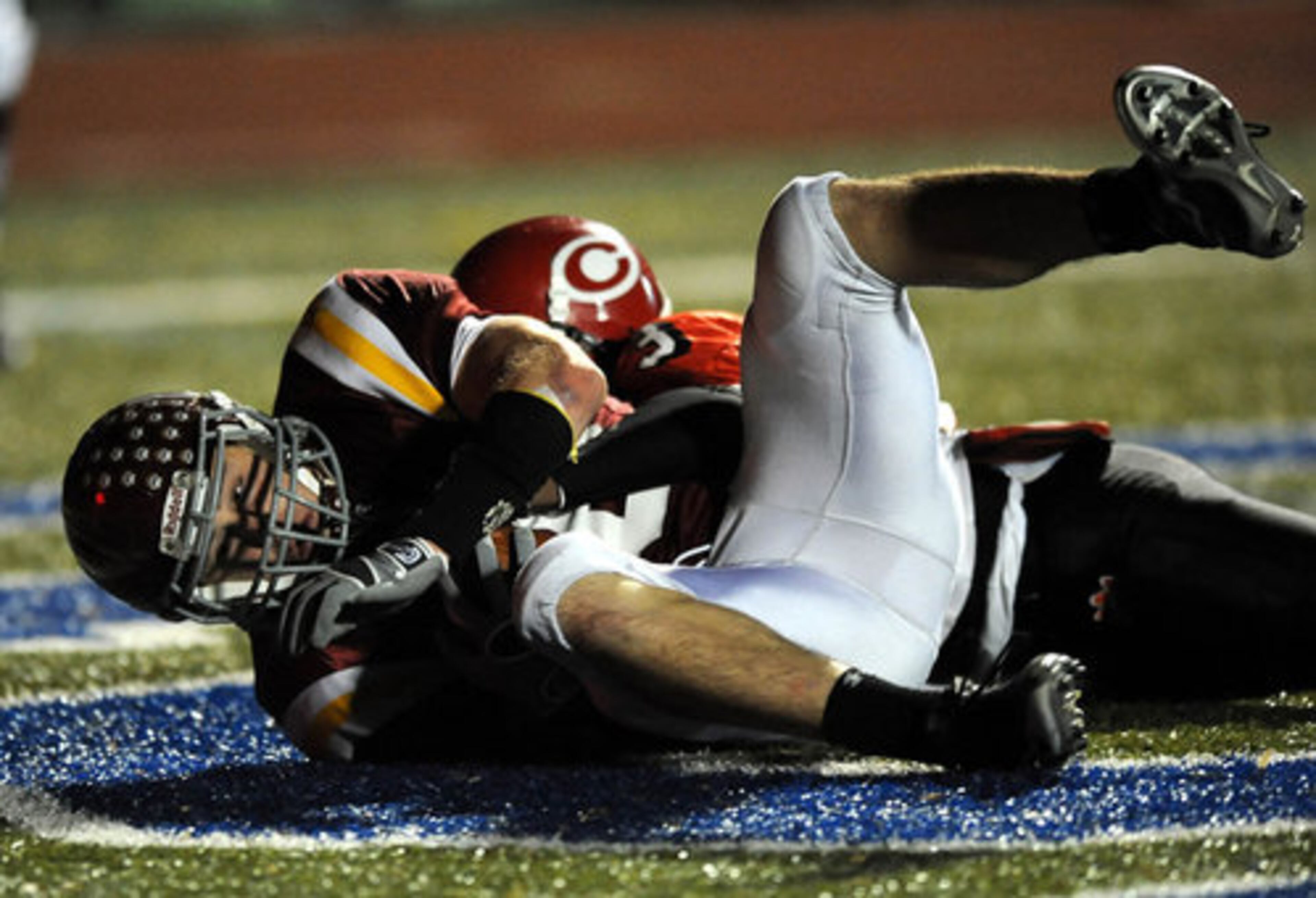 Clinch County's Damian Magby (13) hangs on to the ball through Innocents' Jordan Miller tackle for a touchdown.