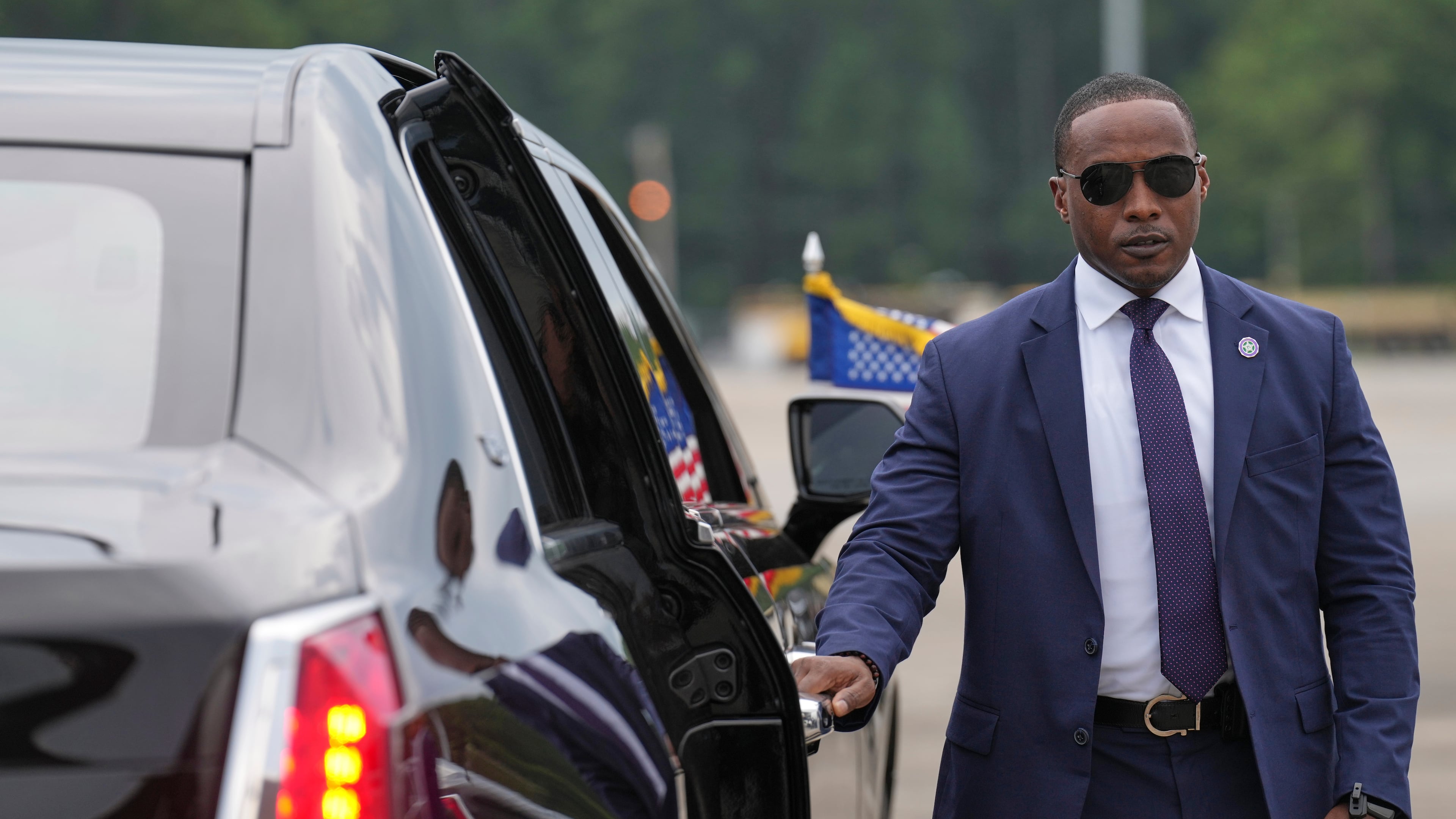 A member of the U.S. Secret Service stands before President Donald Trump arrives to board his limousine at Myrtle Beach International Airport in Myrtle Beach, S.C., Friday, Aug. 21, 2026. (AP Photo/Jacquelyn Martin)