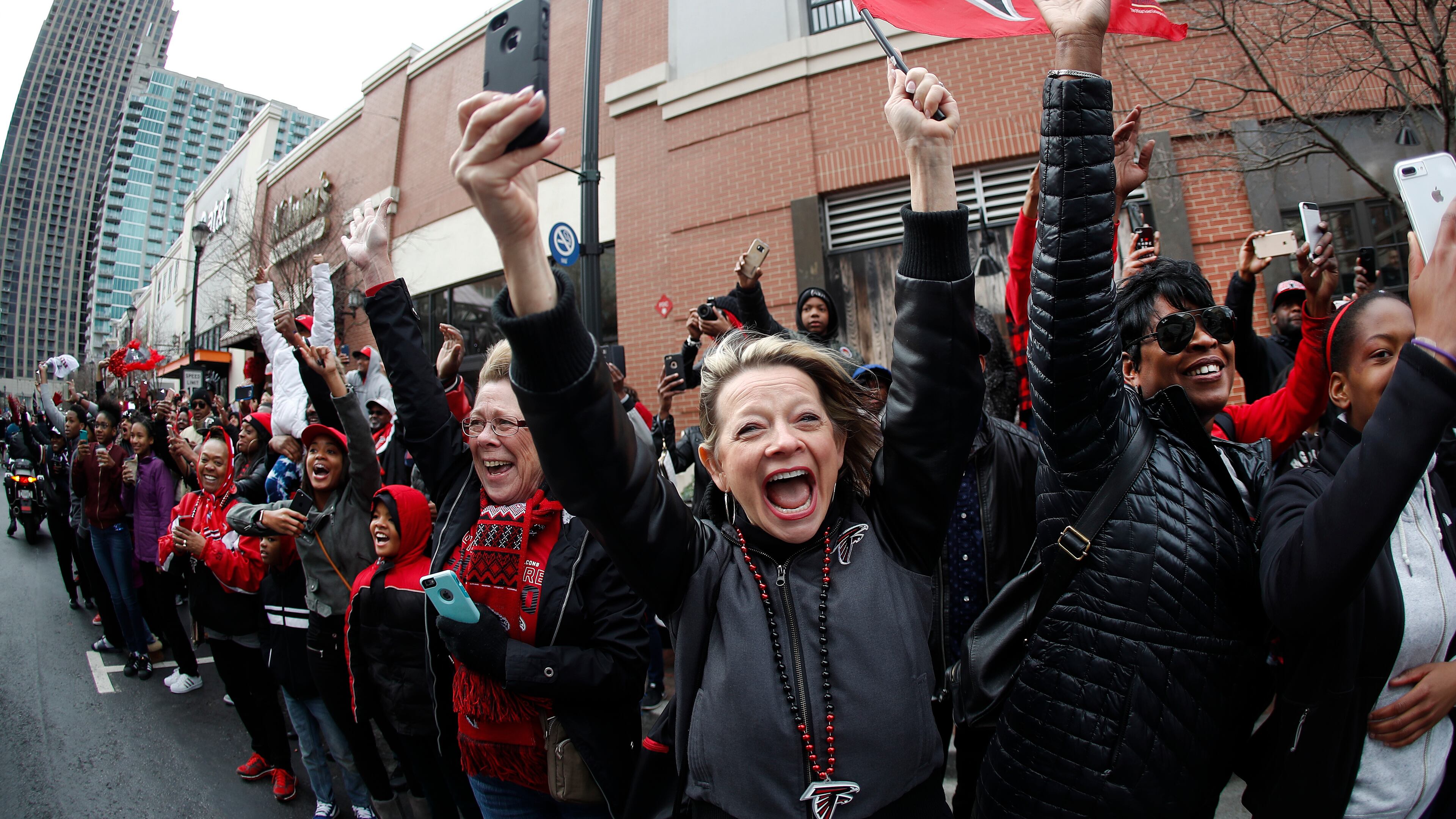 Buses carrying the Atlanta Falcons NFL football team are greeted by cheering fans during a send-off pep rally as they make their way to the airport for a flight to Houston and Super Bowl LI, Sunday, Jan. 29, 2017, in Atlanta.