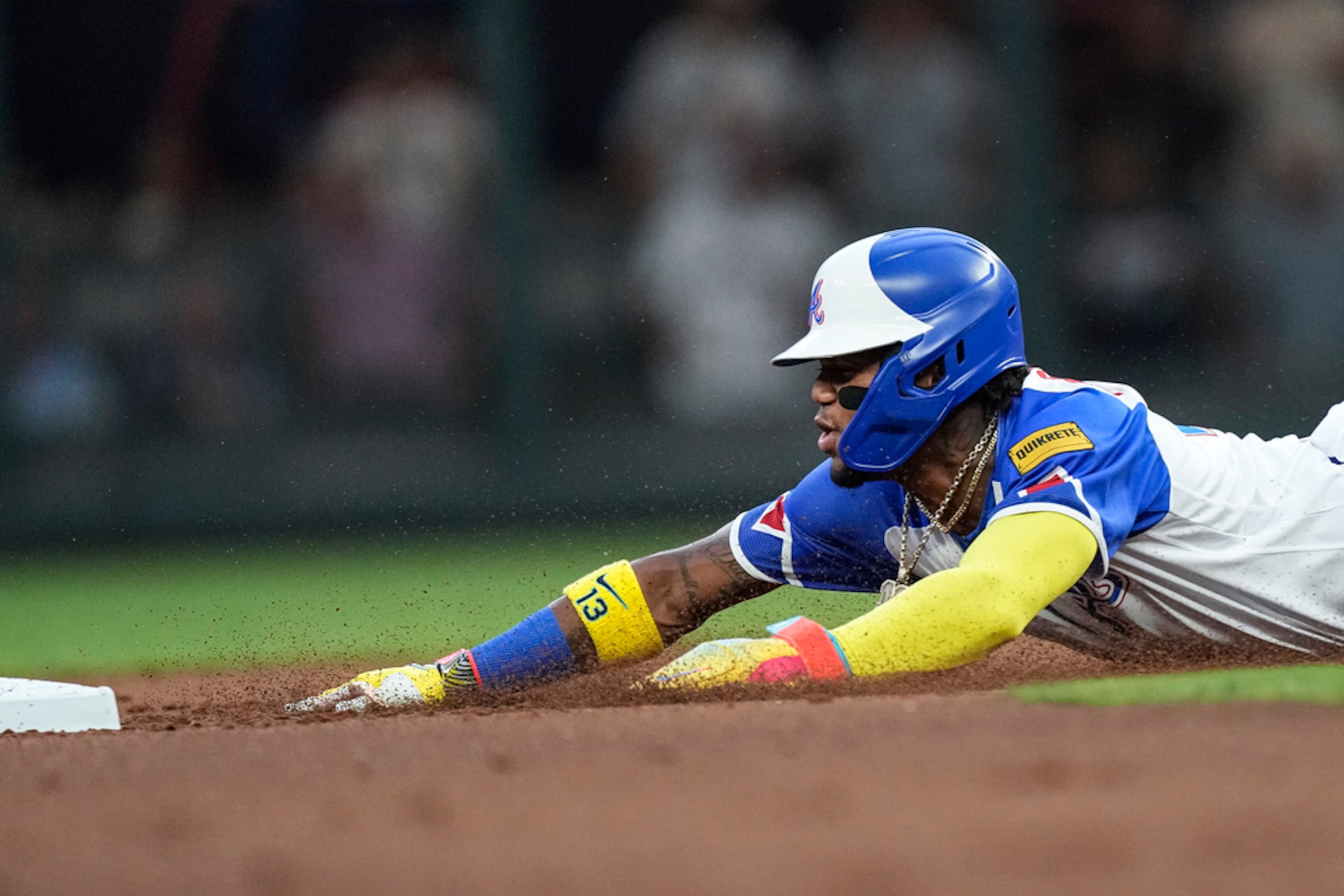Atlanta Braves' Ronald Acuna Jr. advances to second base on an Ozzie Albies fly ball during the first inning of the team's baseball game against the Milwaukee Brewers on Friday, July 28, 2023, in Atlanta. (AP Photo/John Bazemore)