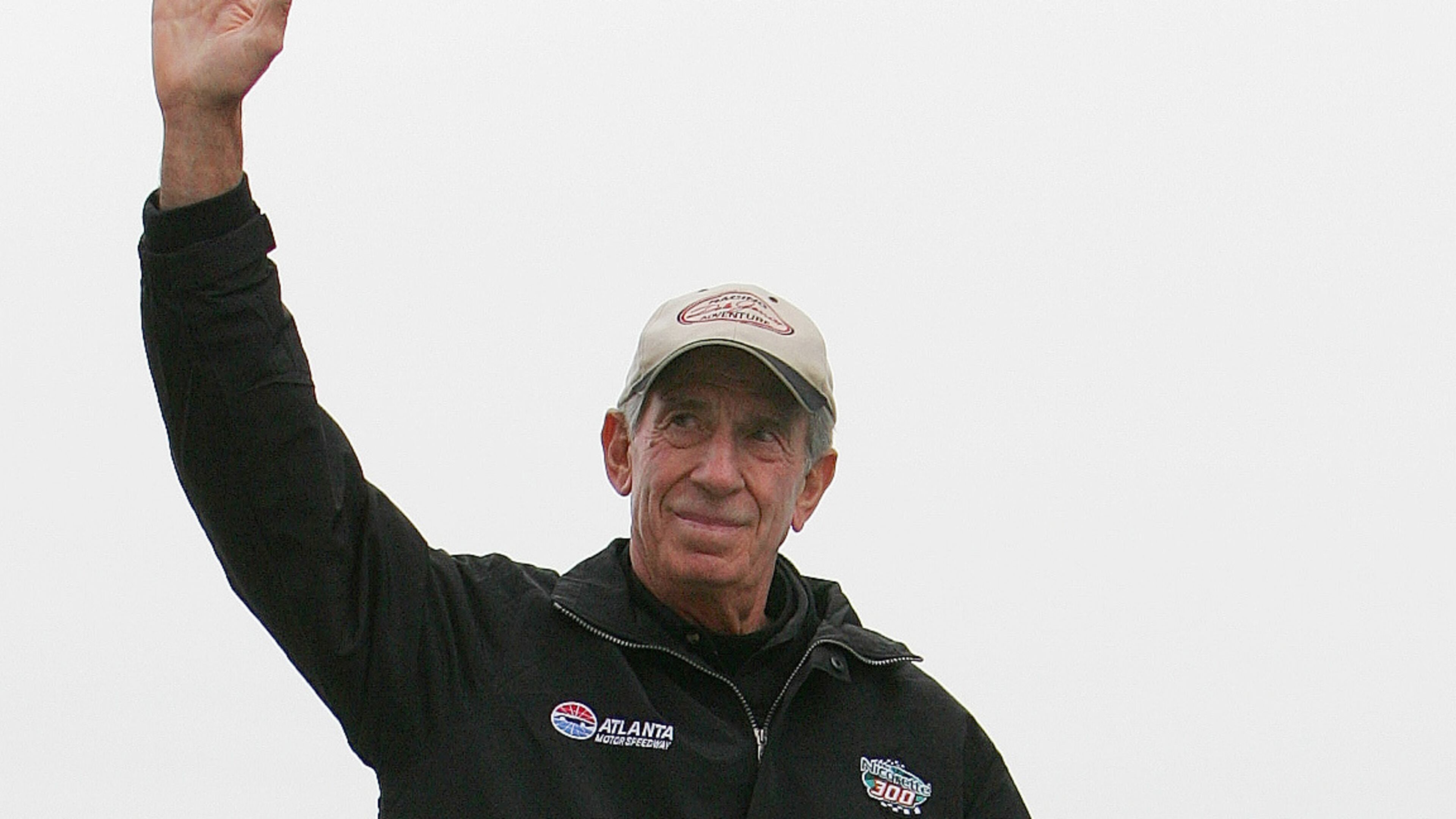 FILE - NASCAR legend Ned Jarrett waves to the fans as he is introduced before the start of the NASCAR BUSCH Nicorette 300 at Atlanta Motor Speedway in Hampton, Ga., March 18, 2006. (AP Photo/John Amis, File)