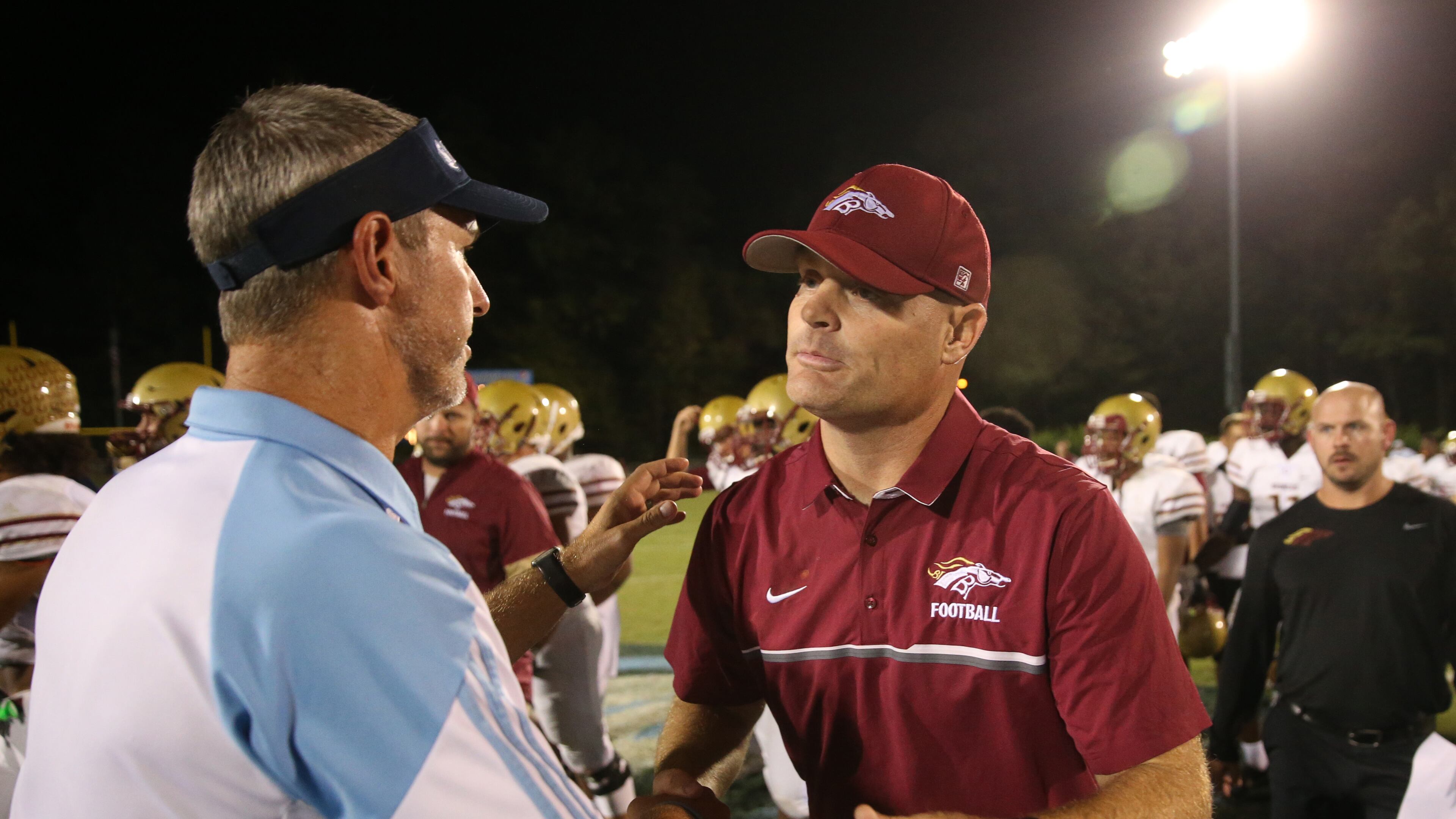October 6, 2017 - Norcross, Ga: Meadowcreek head coach Jason Carrera, left, greets Brookwood head coach Philip Jones after their game at Meadowcreek High School Friday, October 6, 2017, in Norcross. PHOTO / JASON GETZ