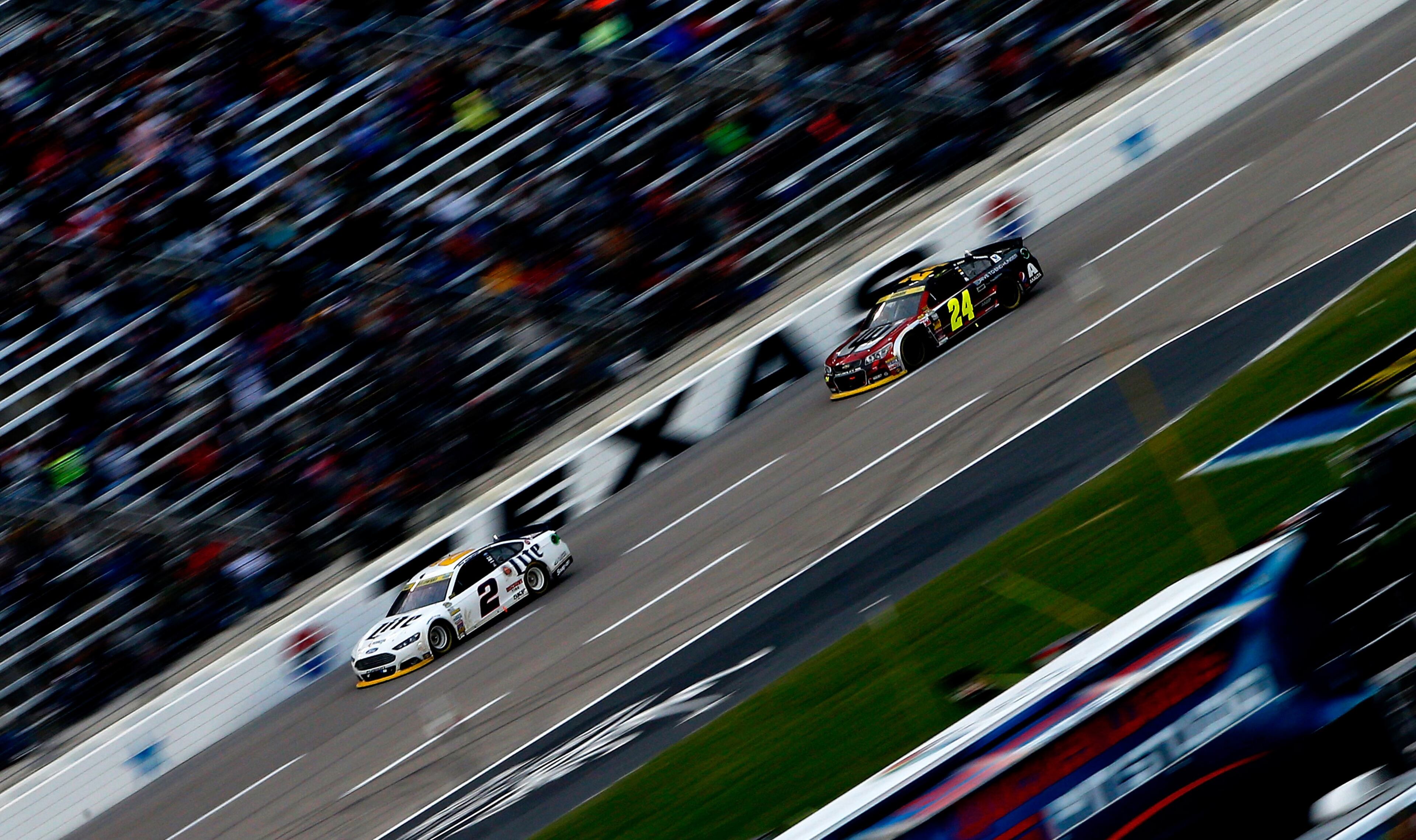 FORT WORTH, TX - NOVEMBER 02: Brad Keselowski, driver of the #2 Miller Lite Ford, leads Jeff Gordon, driver of the #24 Drive To End Hunger Chevrolet, during the NASCAR Sprint Cup Series AAA Texas 500 at Texas Motor Speedway on November 2, 2014 in Fort Worth, Texas. (Photo by Sean Gardner/Getty Images for Texas Motor Speedway)