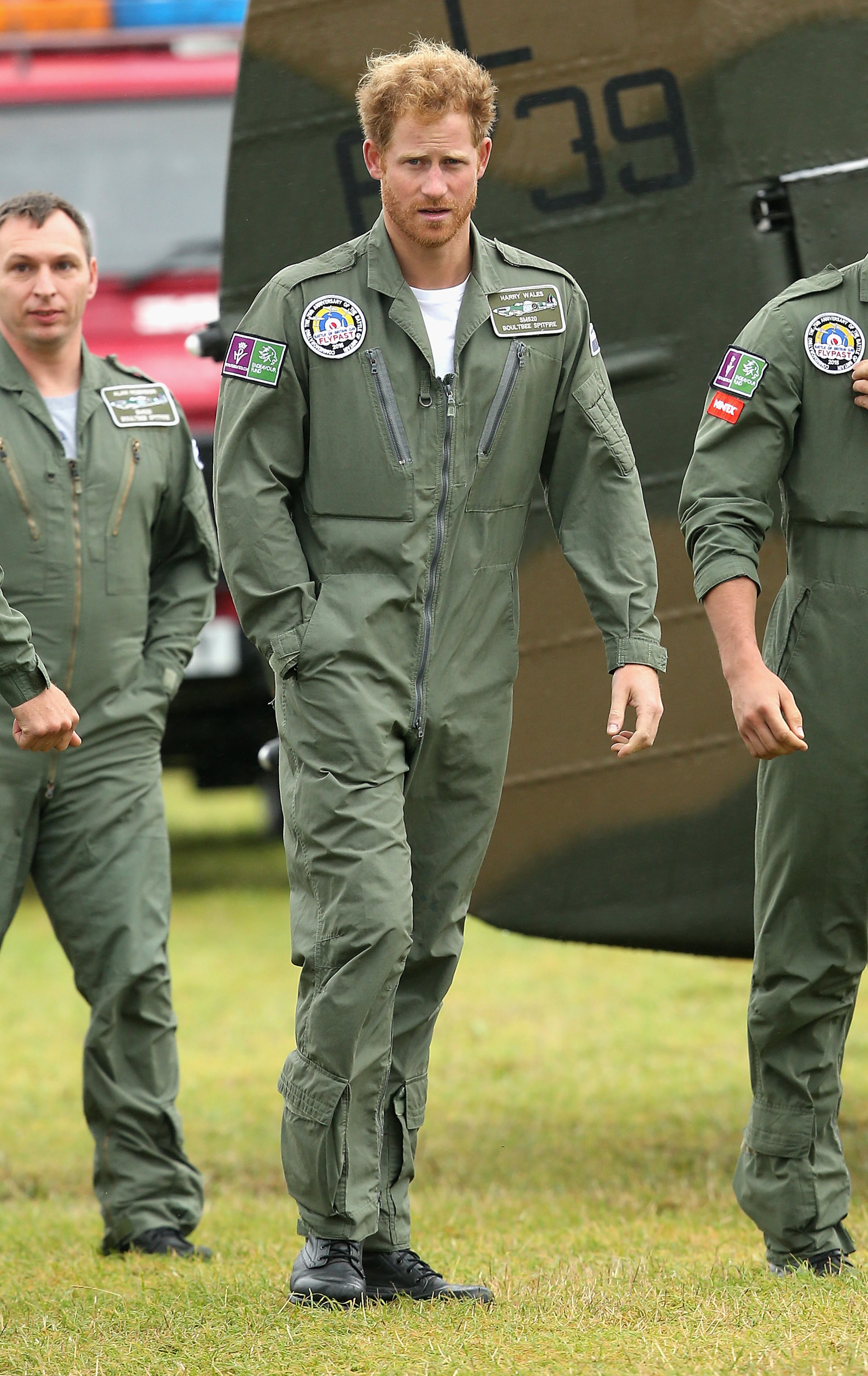 CHICHESTER, ENGLAND - SEPTEMBER 15: Prince Harry walks on the airfield at Goodwood Aerodrome as he is shown a Spitfire Aircraft that will take place in a Battle of Britain Flypast at Goodwood on September 15, 2015 in Chichester, England. The 75th Anniversary of the Battle of Britain is being marked by a historic flypast that brings more Battle of Britain aircraft together than ever before as a show of thanks to 'the few' and the sacrifices they made. (Photo by Chris Jackson/Getty Images)