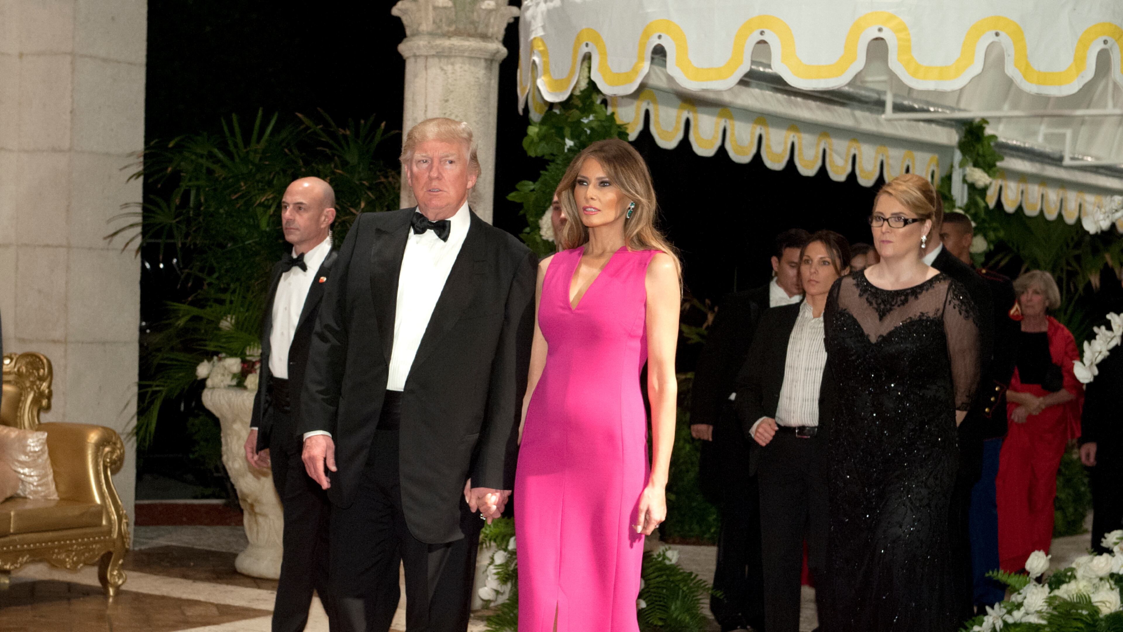 President Donald Trump and Melania Trump arrive at the Diamond Centennial Red Cross Ball at Mar-a-Lago Club Saturday.