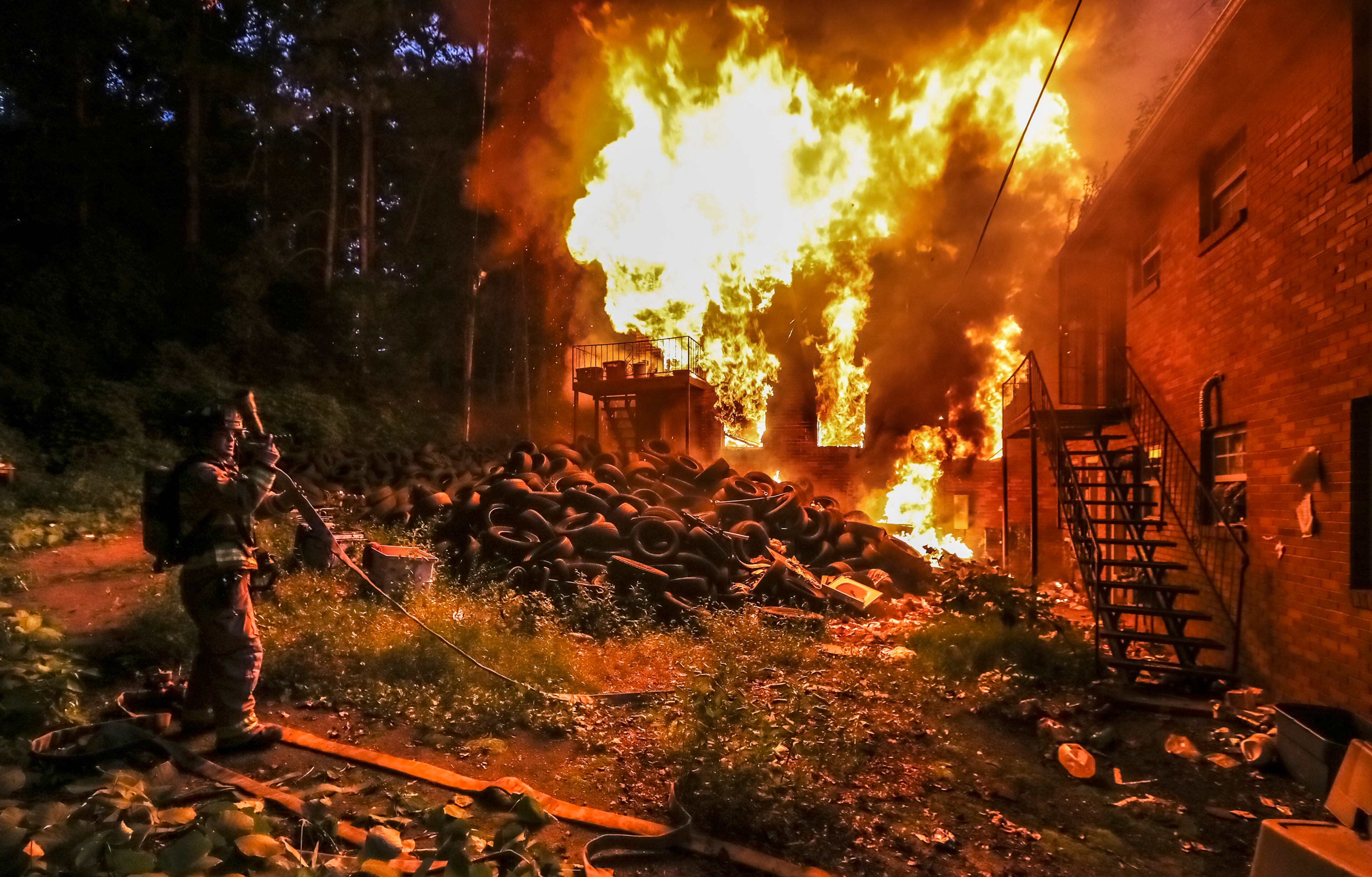 August 7, 2018 Atlanta: A massive fire at a northwest Atlanta apartment building was brought under control after a burning pile of tires set the building ablaze Tuesday morning August 7, 2018. The building, located in the 100 block of Fairfield Place, is vacant and the illegal dumping ground for hundreds of tires, according to Atlanta fire officials. The alarm went out about 6:30 a.m., and the fire was fully involved by 7 a.m. About 40 fire personnel responded to the scene, Atlanta fire spokesman Sgt. Cortez Stafford told AJC.com. No one was injured. For several hours Tuesday, firefighters worked to knock down towering flames. Smoke from the scorched pile of rubber could be seen from I-20 but did not affect traffic, according to theâ WSB 24-hour Traffic Center.â The fire was under control about 9:20 a.m.â A foam unit was brought in to put out any remaining hot spots.â The cause of the fire is still under investigation. ìOur fire investigators are looking at a person of interest at this timeâ that possibly set the fire,î Stafford said. JOHN SPINK/JSPINK@AJC.COM