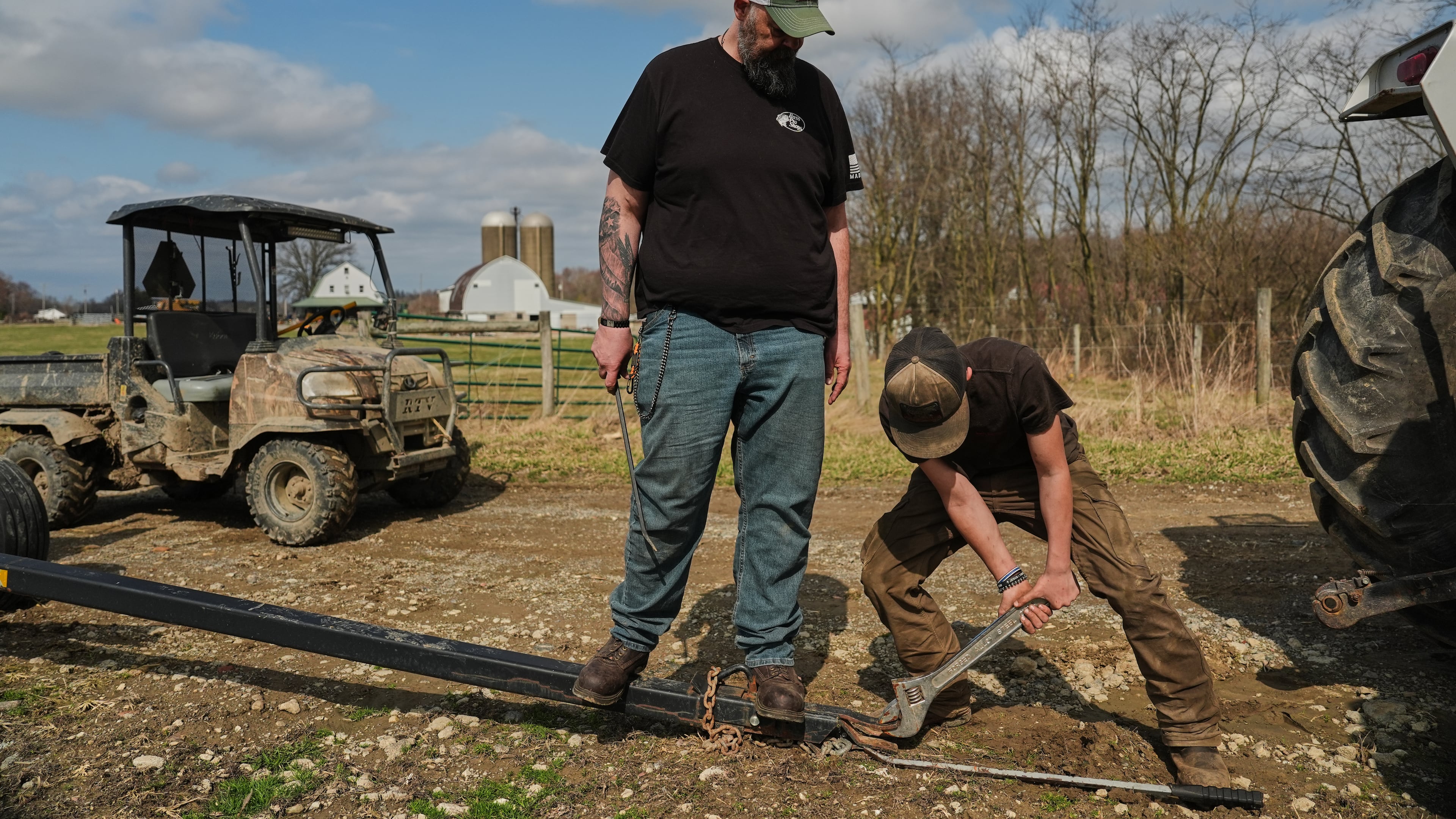 Blake Greier, 13, works to repair a hitch as his father, Wayne, left, helps Tuesday, March 10, 2026, in Canfield, Ohio. (AP Photo/Joshua A. Bickel)