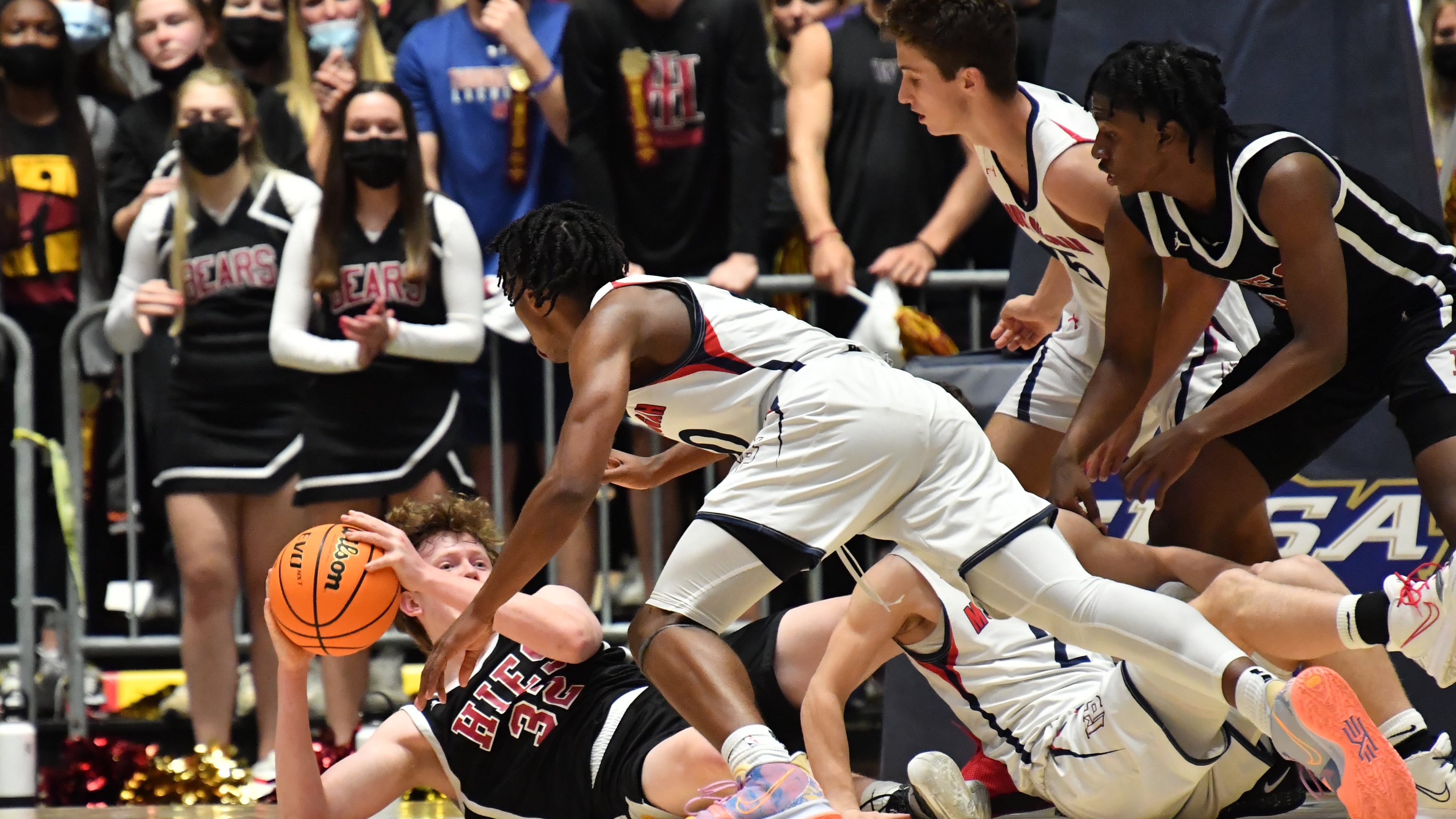 March 10, 2021 Macon - Holy Innocents' Walker Wolf (32) holds onto a loose ball as he falls to the court during the 2021 GHSA State Basketball Class A Private Championship game at the Macon Centreplex in Macon on Wednesday, March 10, 2021. Mt. Pisgah won 43-41 over Holy Innocents. (Hyosub Shin / Hyosub.Shin@ajc.com)