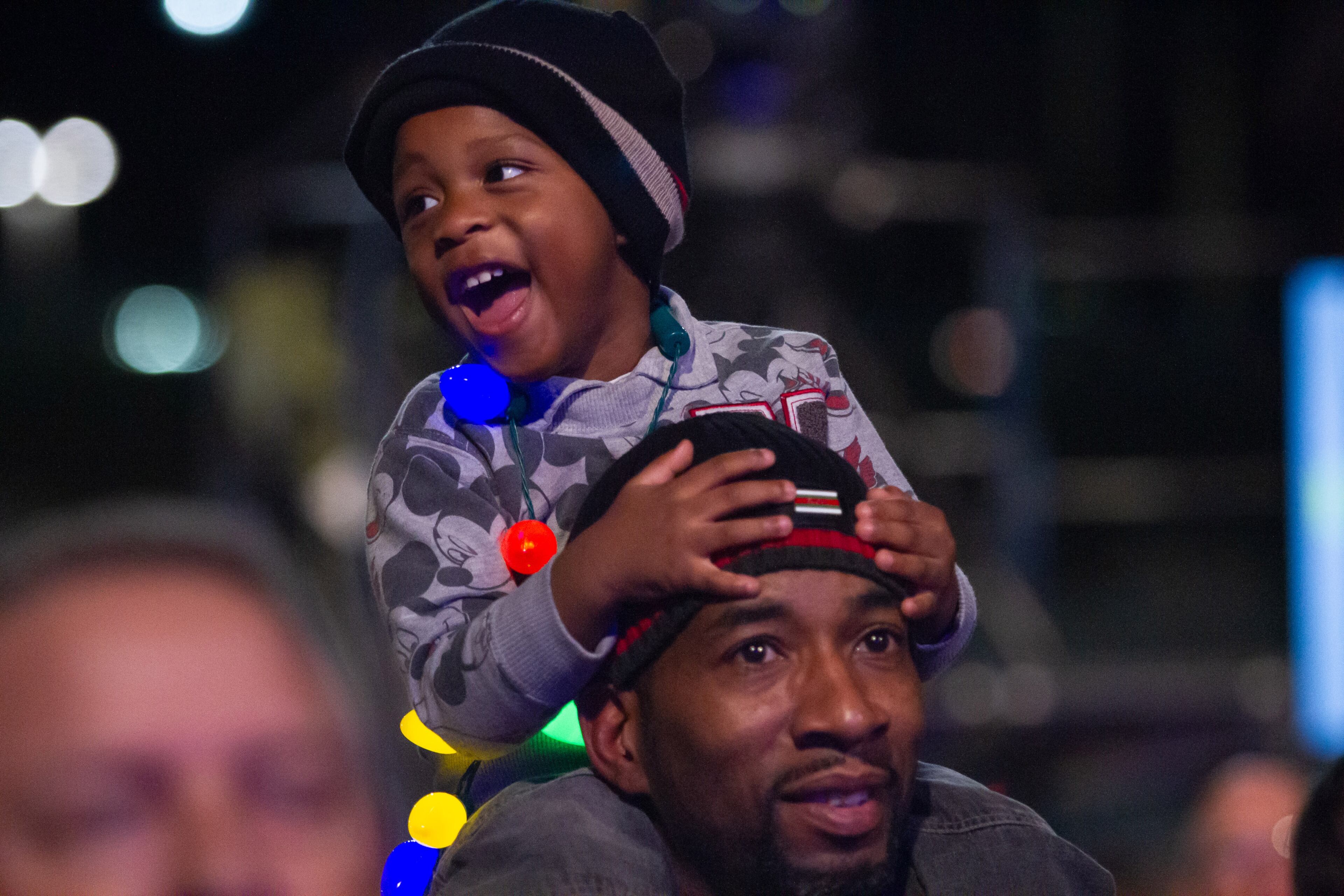 Djuan Hart, 3, rides on his Grandfathers, Dotruell Jordan, shoulders during the Macy's 71st Annual Great Tree Lighting ceremony at Lenox Square mall in Atlanta GA. Sunday, November 18, 2018. STEVE SCHAEFER / SPECIAL TO THE AJC