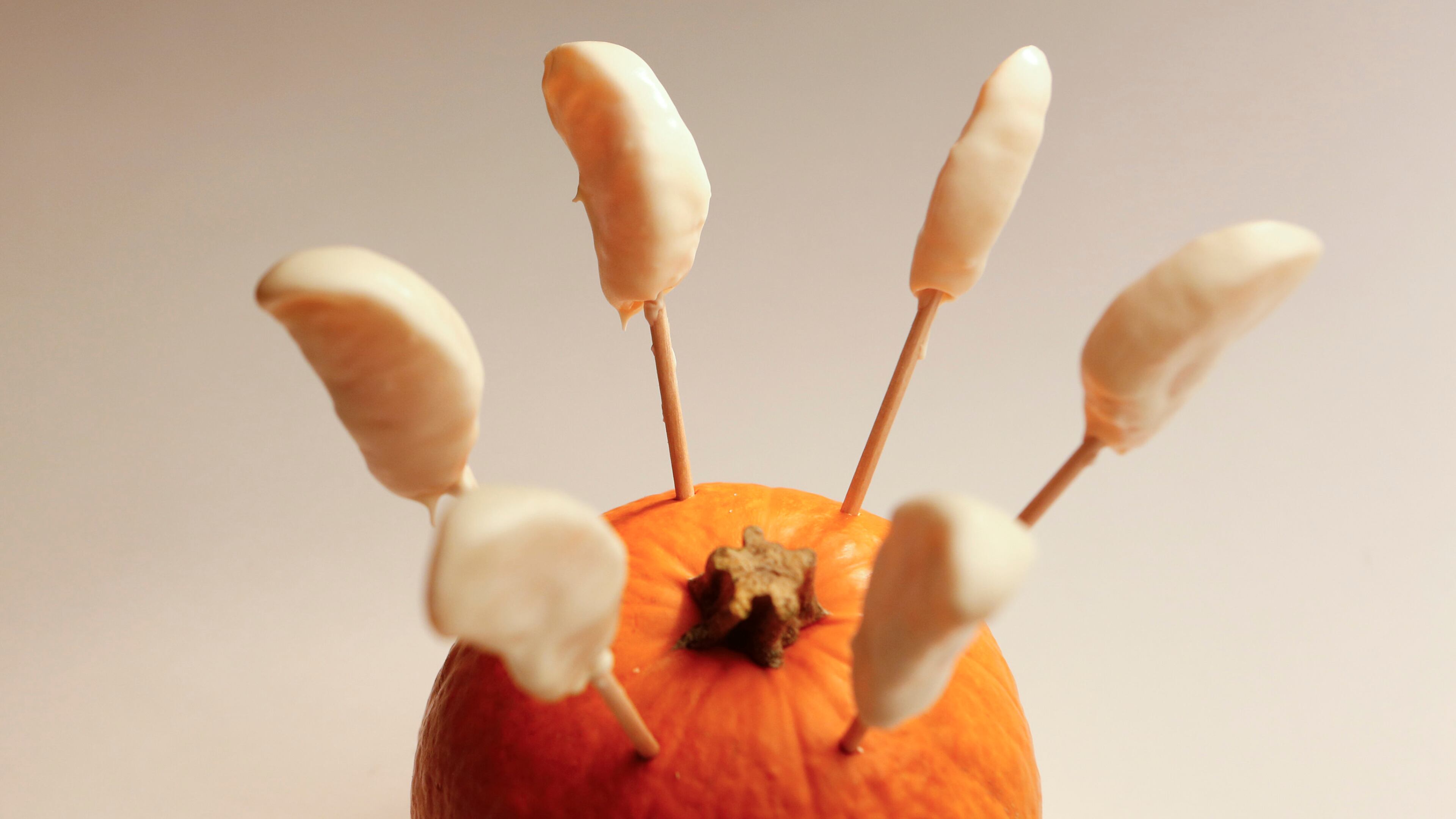 Peel the skin from an orange and top each slice with melted chocolate (either melted chocolate chips or, if using white chocolate, look for white "melting" chocolate). Form the eyes with candy decorations or melted chocolate. Bananas can easily be substituted for the orange slices. (Anne Cusack/Los Angeles Times/MCT)