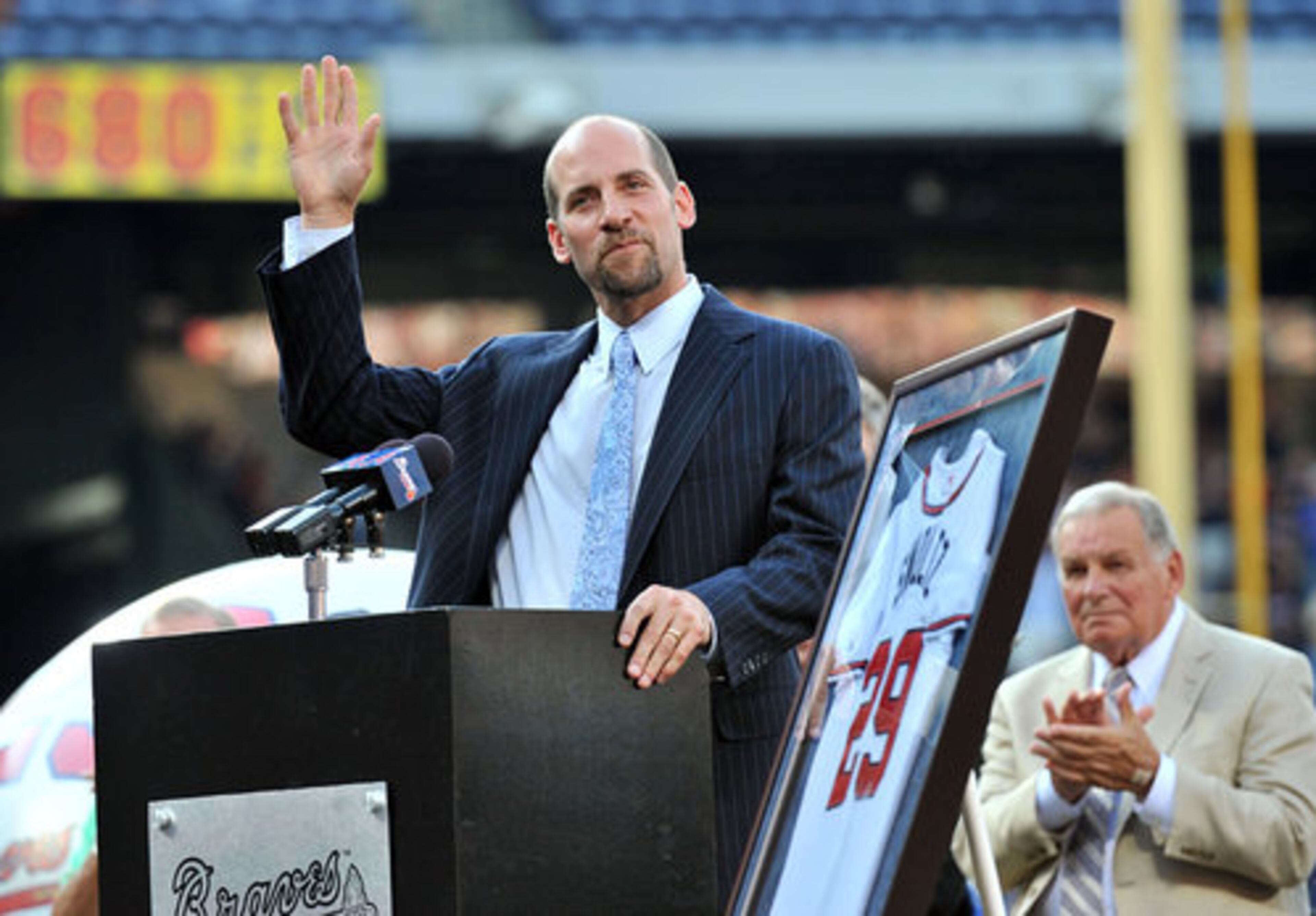 John Smoltz waves to fans during his number retirement ceremony.