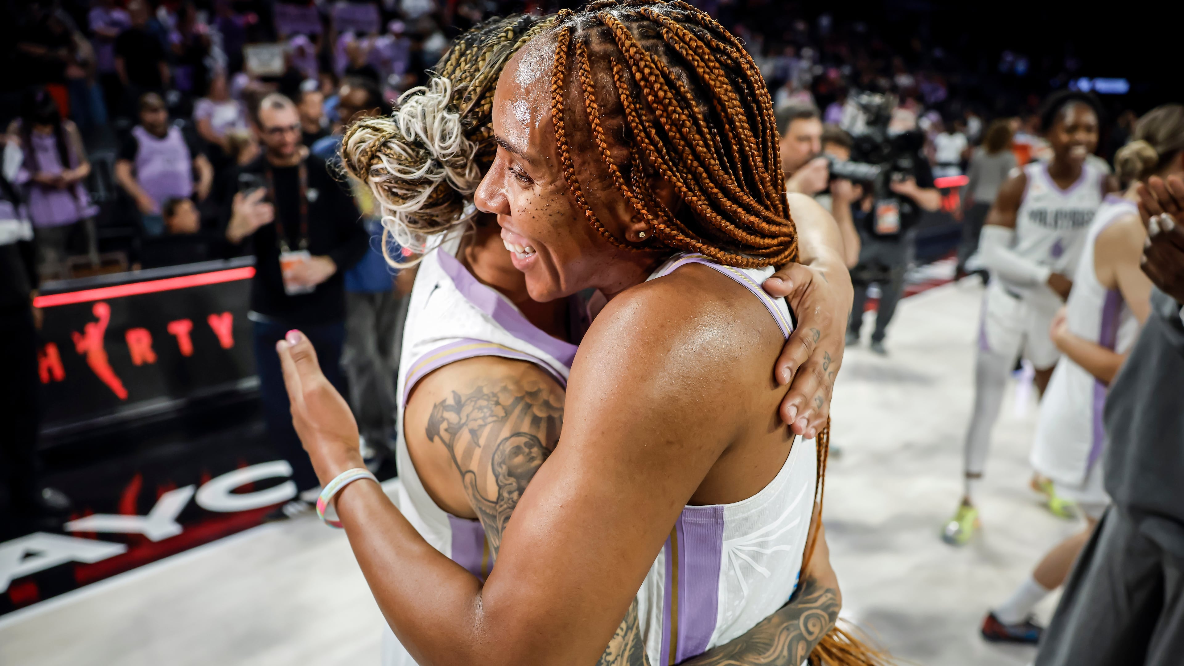 Golden State Valkyries' Kayla Thornton (5) hugs Gabby Williams (1) after the Golden State Valkyries defeated the Las Vegas Aces 87-77 in Game 3 of the 2026 WNBA playoffs semifinals at Michelob Ultra Arena in Las Vegas on Friday, Oct. 9, 2026. (Carlos Avila Gonzalez/San Francisco Chronicle via AP)
