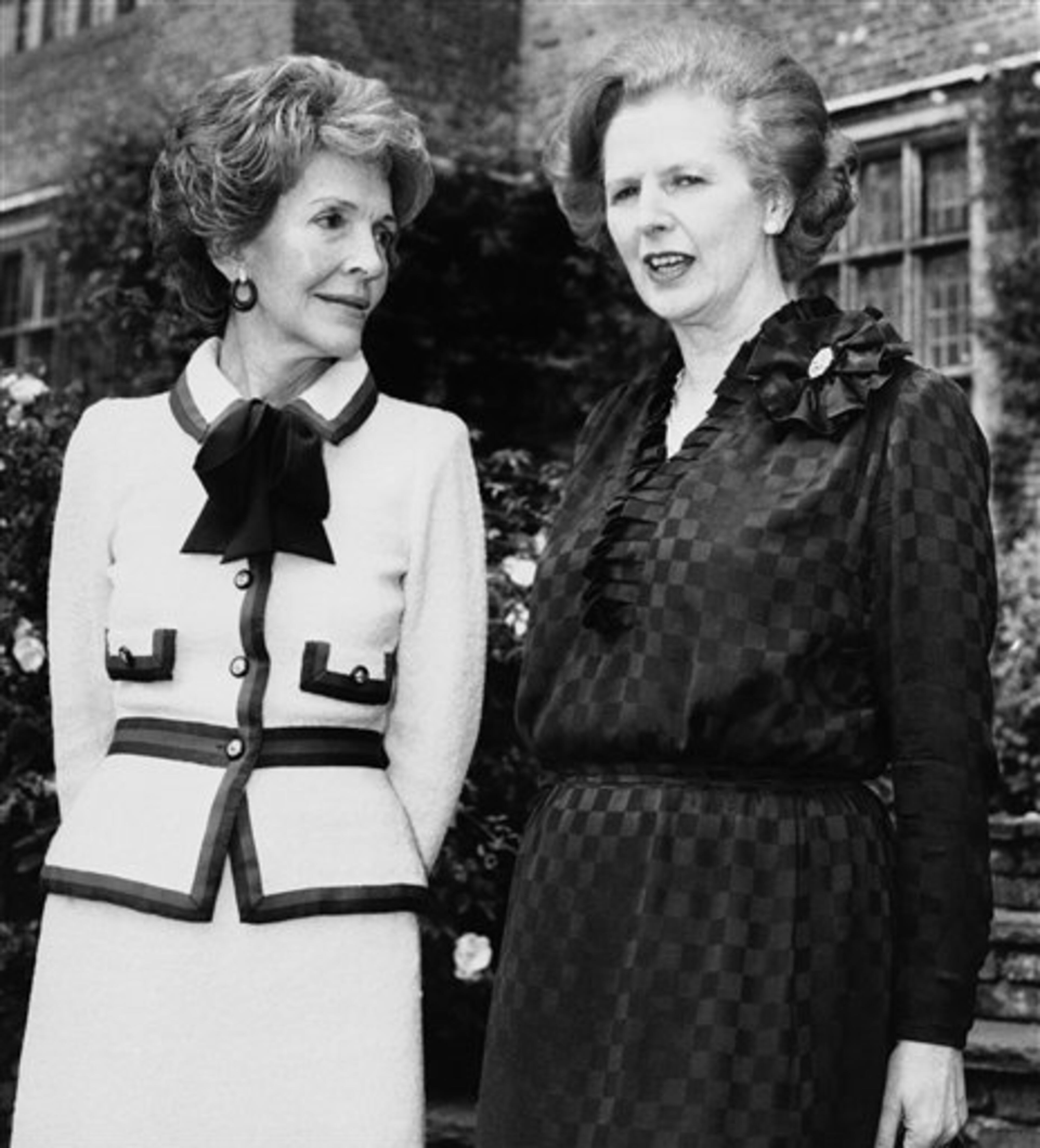 Nancy Reagan and Margaret Thatcher, respectively wife of President Ronald Reagan and British Prime Minister, provide a contrast in styles as they meet, Saturday, July 25, 1981 at Chequers, the official country residence of British Prime Ministers in Oxford, England. (AP Photo/Peter Tyrell)