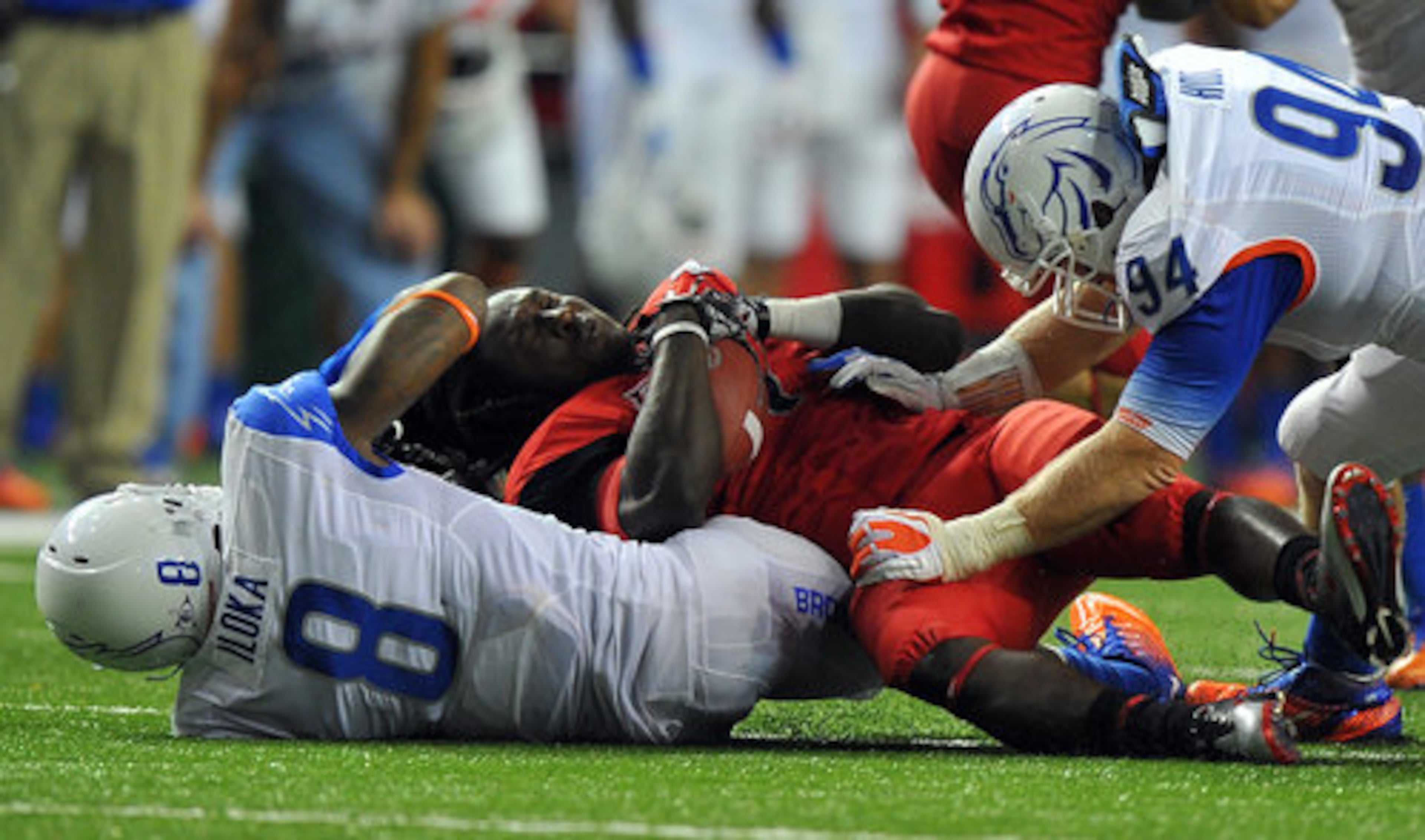 Georgia running back Isaiah Crowell loses his helmet as he is tackled by Boise State's George Iloka.