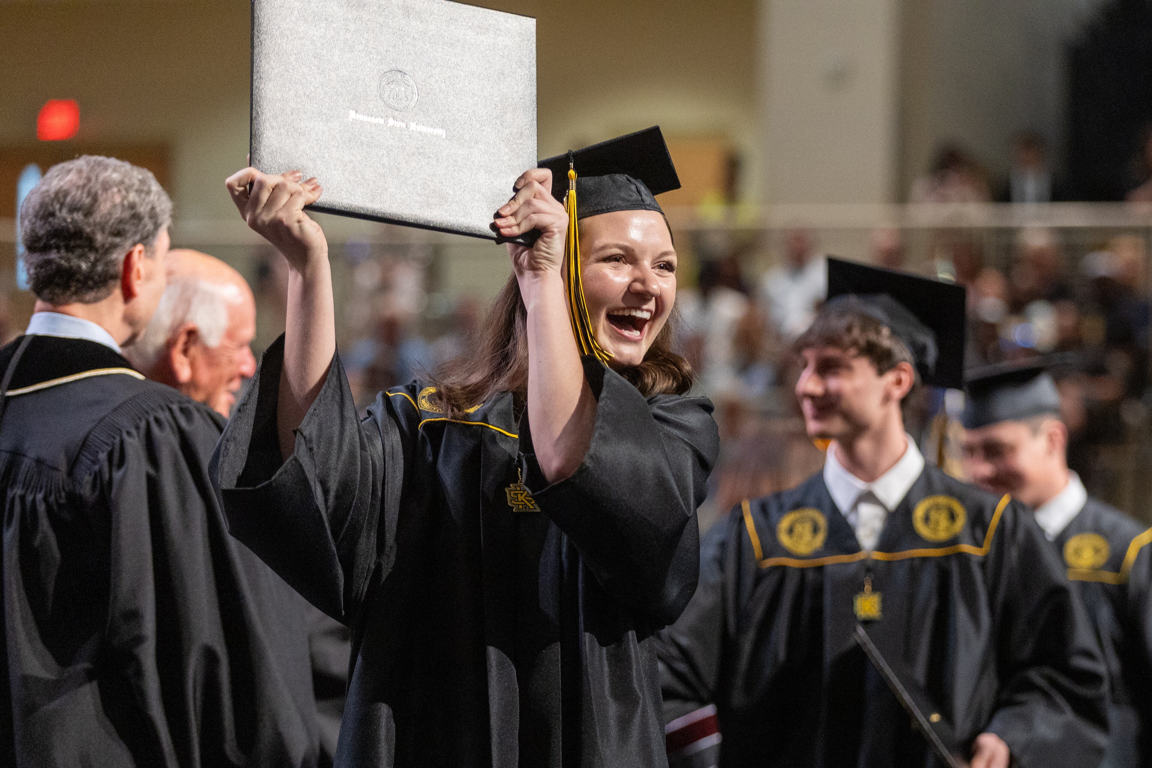 Rebecca Verlander reacts after receiving her diploma at Kennesaw State University on Tuesday, May 7, 2014. (Steve Schaefer / AJC)
