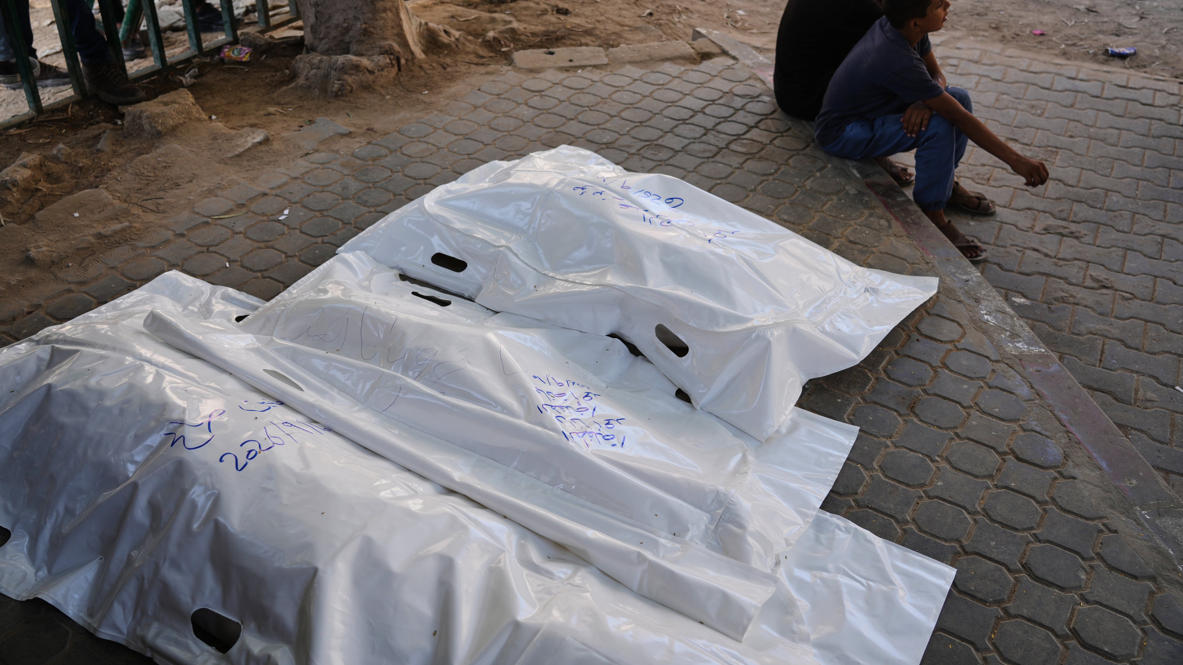 Palestinians sit beside the bodies of members of the Ahmed family, including the parents and their two children, who were killed in an Israeli army strike, at Shifa Hospital in Gaza City, Thursday, Sept. 10, 2026. (AP Photo/Jehad Alshrafi)