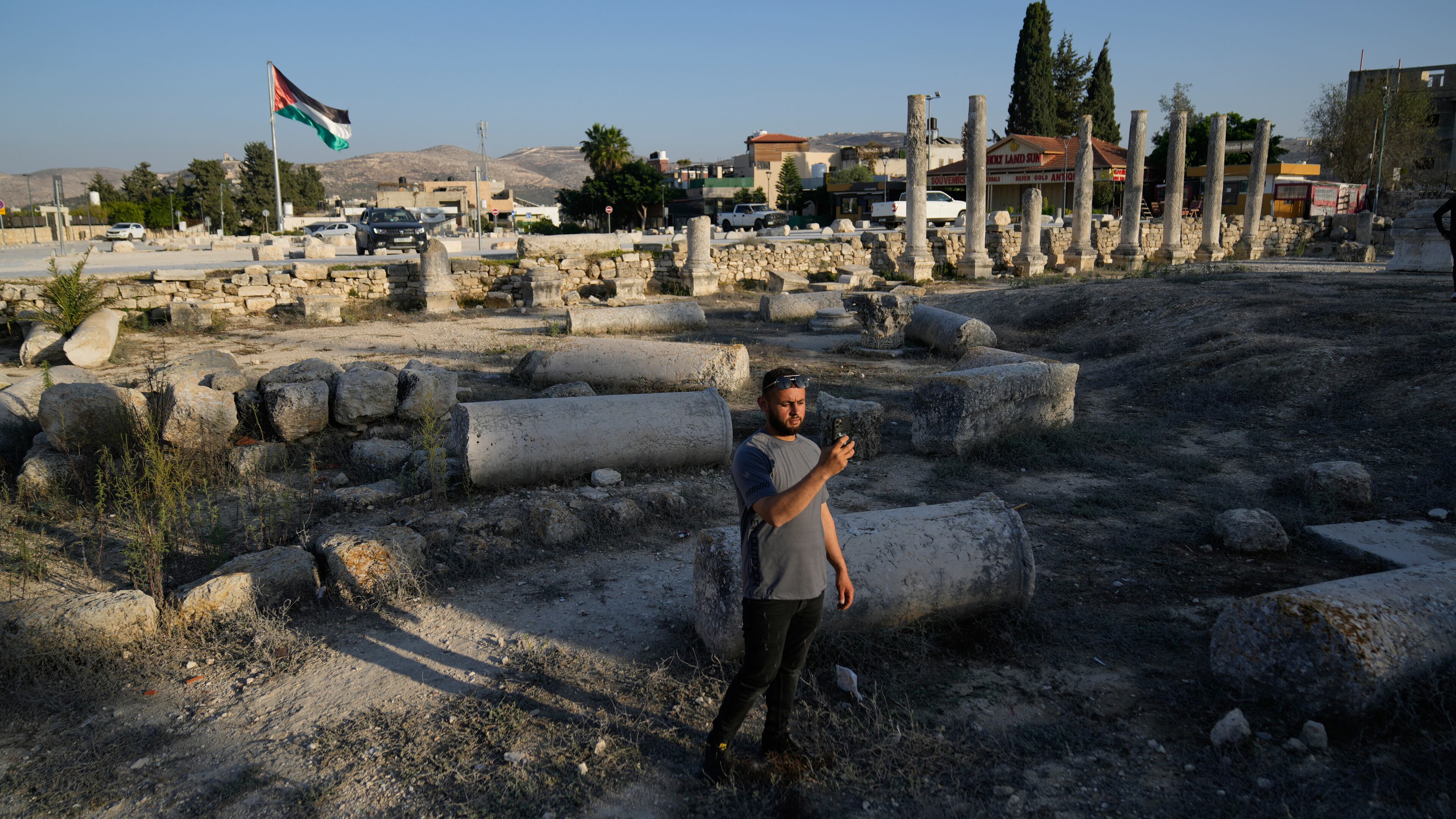 FILE - A Palestinian visitor takes a photo at the Roman historical site in the West Bank town of Sebastia Thursday, Nov. 20, 2025. (AP Photo/Nasser Nasser, File)