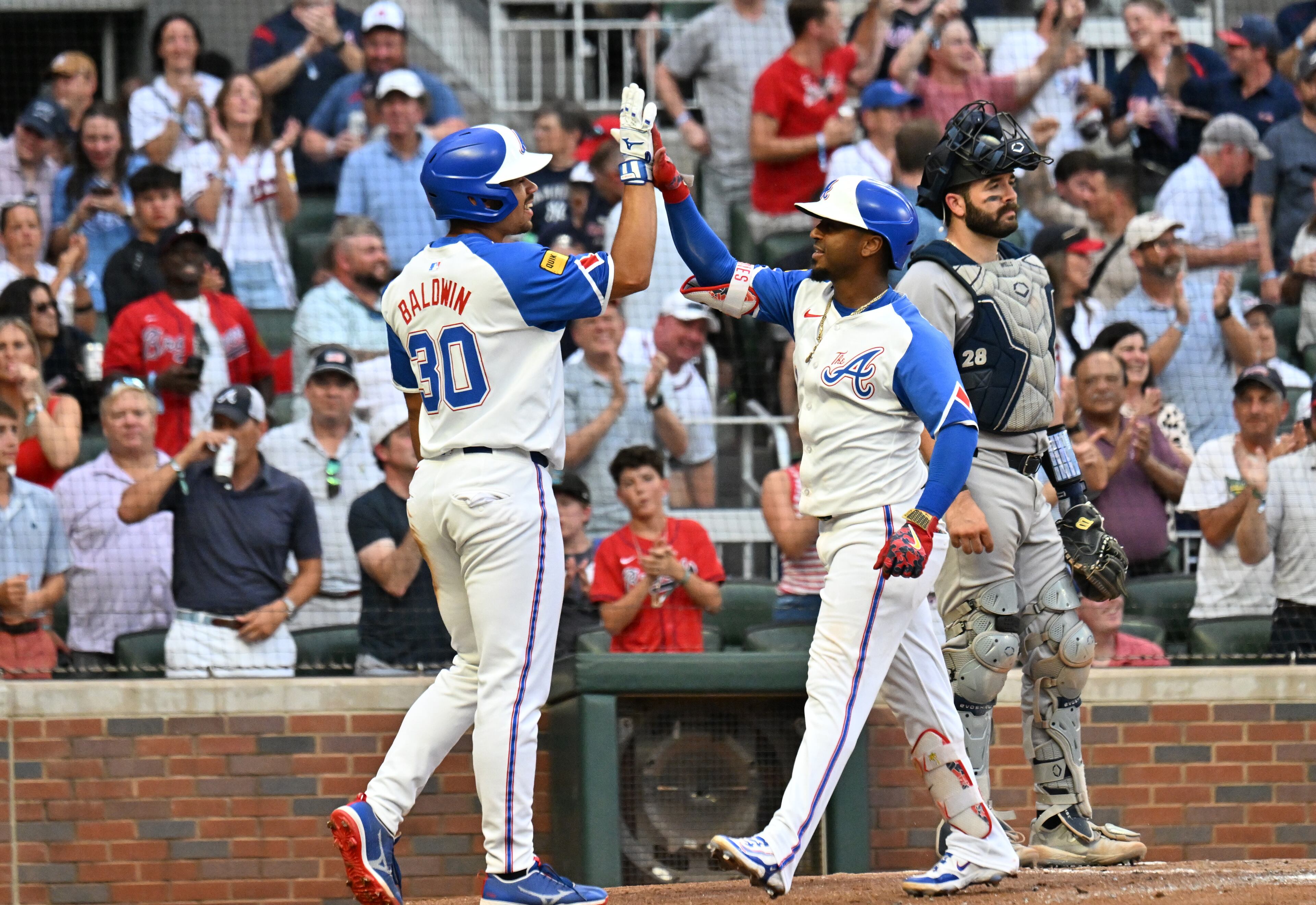 Atlanta Braves second base Ozzie Albies (1) celebrates with Atlanta Braves catcher Drake Baldwin (30) after hitting a 3-run home run during the fourth inning of a baseball game at Truist Park, Saturday, July 19, 2025, in Atlanta. New York Yankees won 12-9 over Atlanta Braves. (Hyosub Shin / AJC)