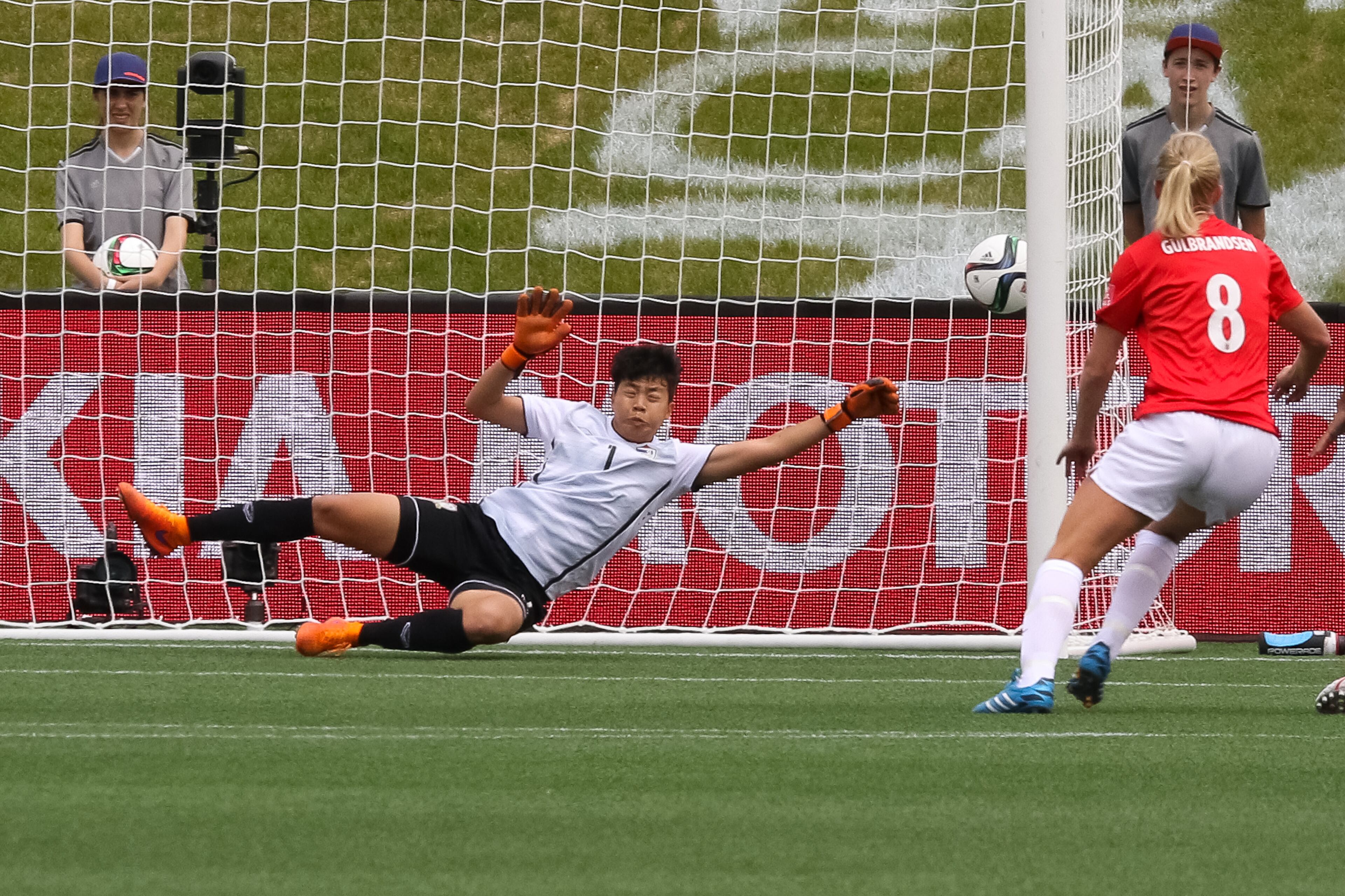 OTTAWA, ON - JUNE 7: Waraporn Boonsing #1 of Thailand gets beaten for a goal from a direct kick by Norway during the FIFA Women's World Cup Canada 2015 Group B play between Norway and Thailand as Solveig Gulbrandsen #8 of Norway looks on at Lansdowne Stadium on June 7, 2015 in Ottawa, Canada. (Photo by Andre Ringuette/Getty Images)