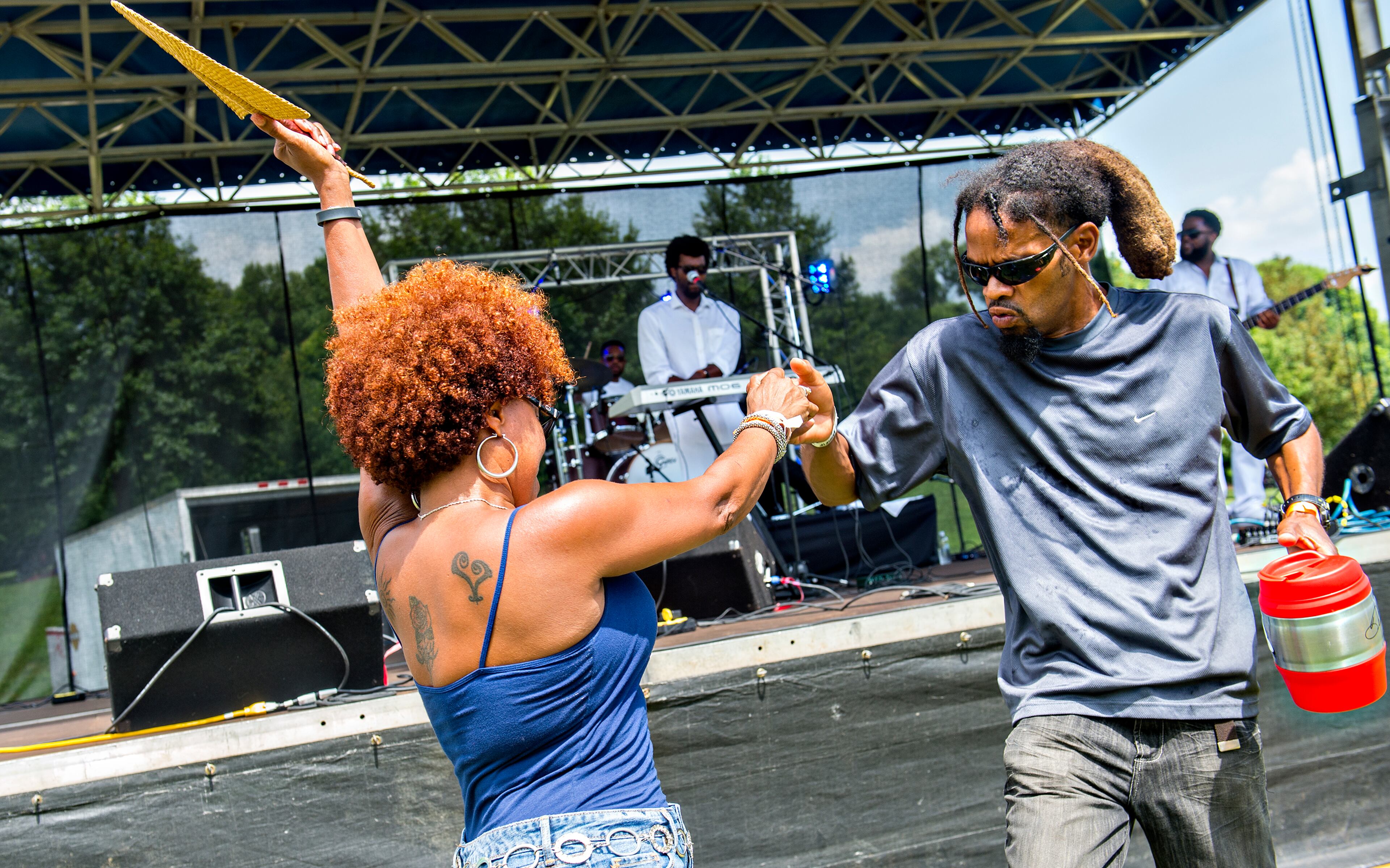 Donny James (right) dances with Patti Jackson as Gritz & Jelly Butter performs on stage during the Atlanta Street Food Festival at Piedmont Park in Atlanta on Saturday, July 11, 2015. Tens of thousands of people attended the fourth annual festival which featured over 50 of Atlanta's favorite food trucks, live music and games. JONATHAN PHILLIPS / SPECIAL