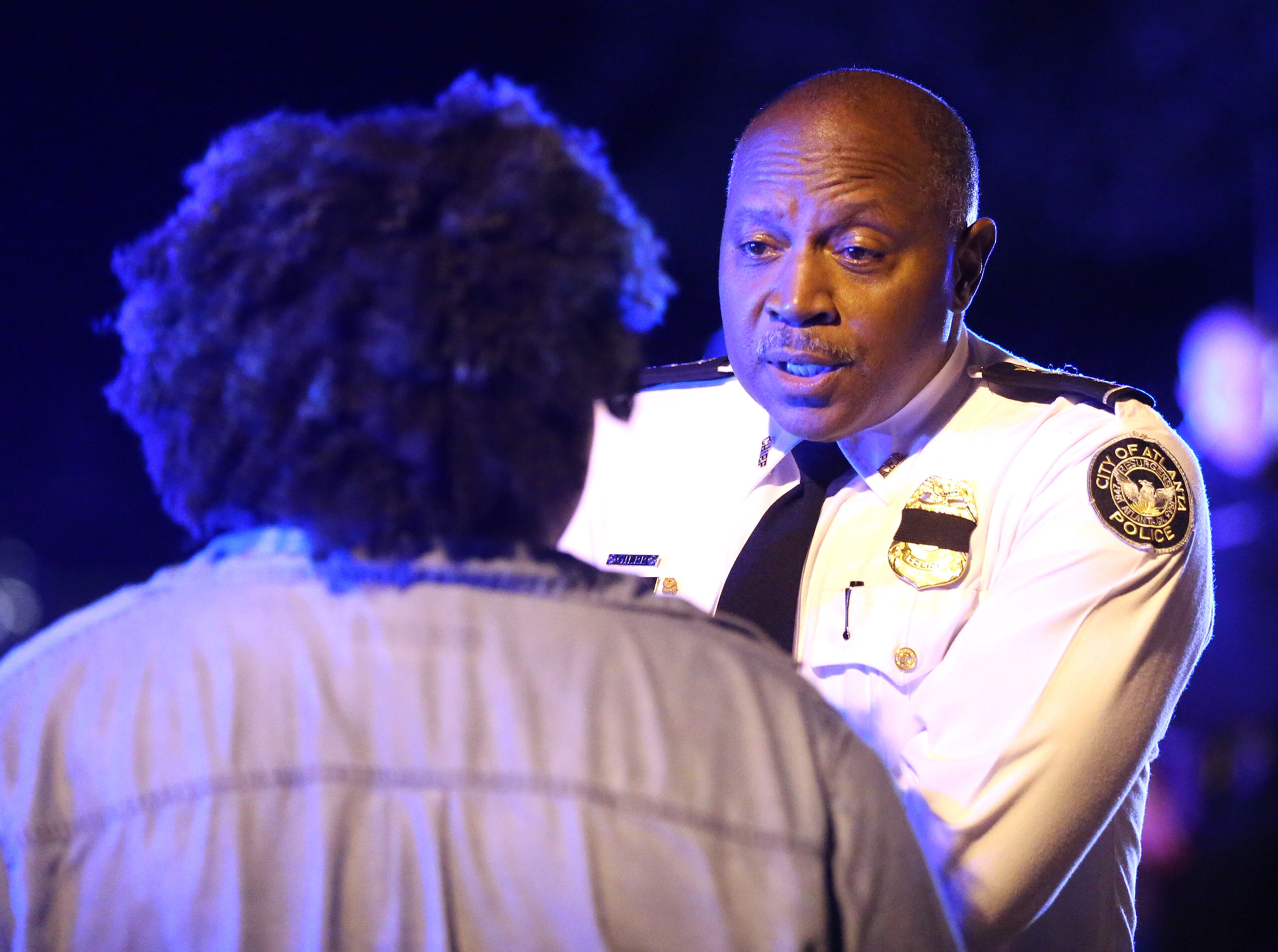 Chief of Police George Turner speaks with a protester outside the Governor's mansion during a fifth night of demonstrations on Monday, July 11, 2016, in Atlanta. Curtis Compton /ccompton@ajc.com