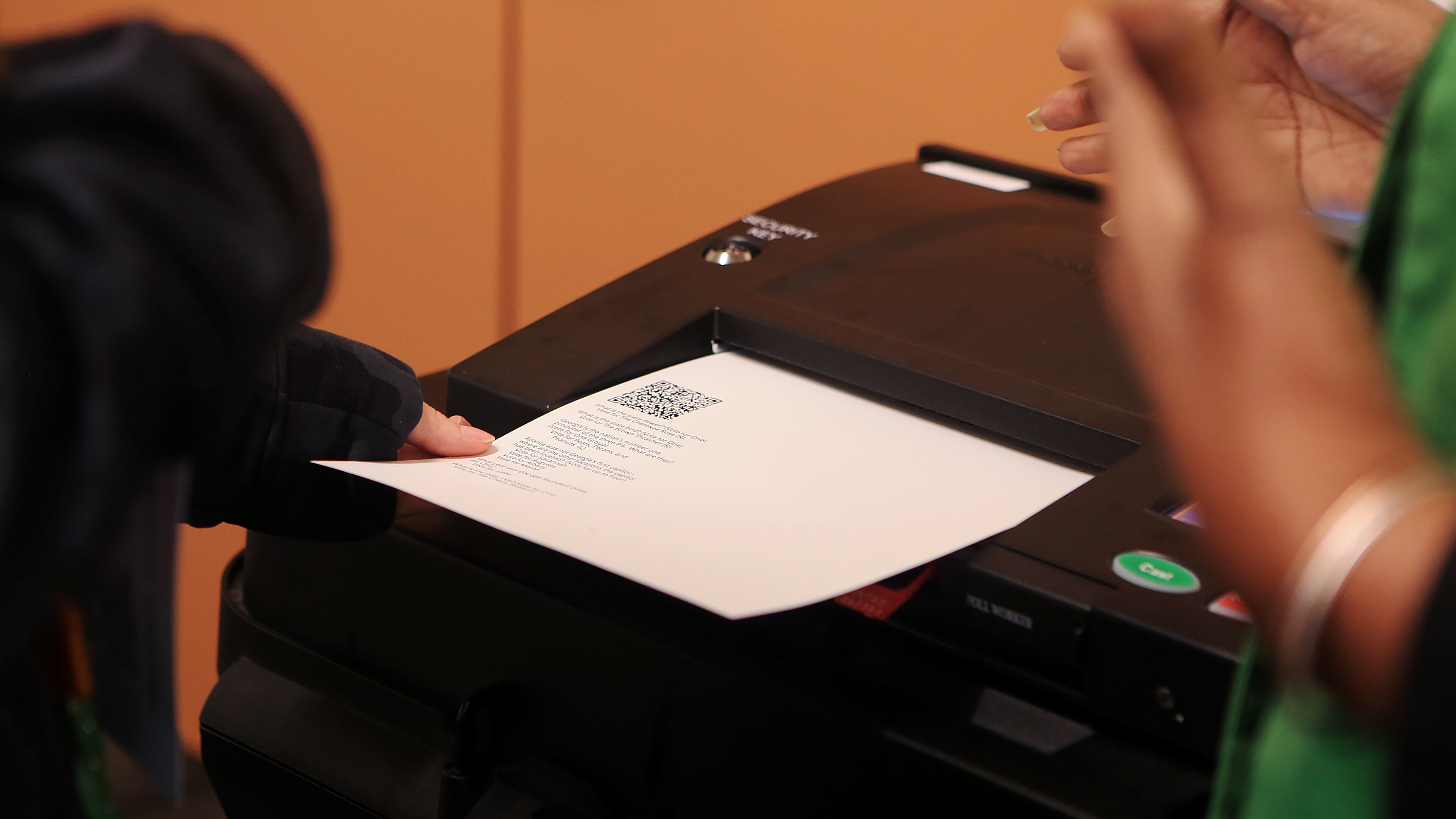 Theresa Carrington (right) assists a woman who wished not to be name (left) cast her ballot during the mock election for Fulton County on Tuesday, February 18, 2020, at the Roswell Library in Roswell, Georgia. Fulton County held a mock election to test out its new voting machines and system. (Christina Matacotta for the Atlanta Journal-Constitution)