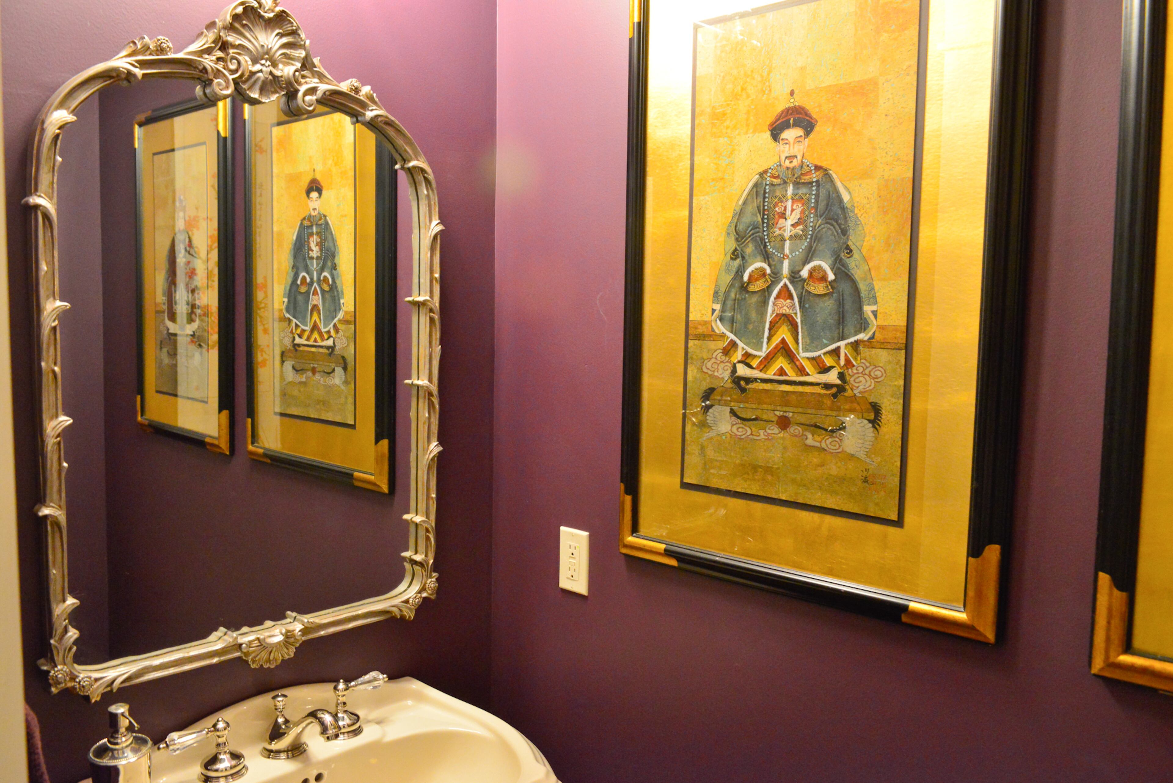 For what Gloria Boone calls her "plum jewel box," she chose Benjamin Moore Aura's Chambourde for the powder room walls. The couple found the Asian artwork on the floor at an antique market in Atlanta's Cheshire Bridge Road area.