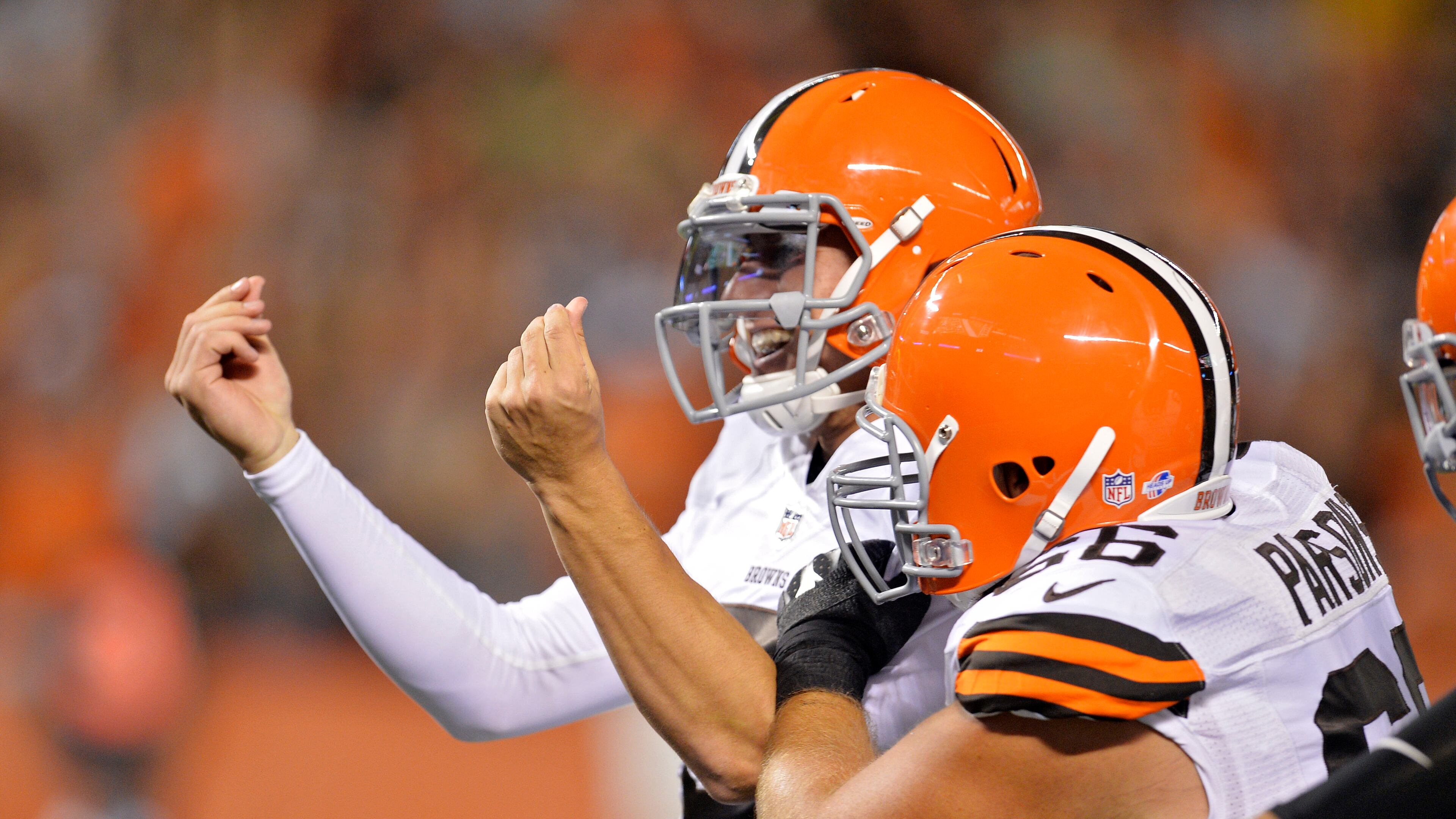 FILE - In this Aug. 23, 2014, file photo, Cleveland Browns quarterback Johnny Manziel celebrates after a 7-yard touchdown run against the St. Louis Rams in the third quarter of a preseason NFL football game, in Cleveland. The Browns have released troublesome quarterback Johnny Manziel. The team cut ties on Friday, March 11, 2016, with the 2012 Heisman Trophy winner after two disappointing, drama-filled seasons. Manziel faces an uncertain future in the NFL and potential criminal charges in Texas following a domestic violence incident. (AP Photo/David Richard, File)