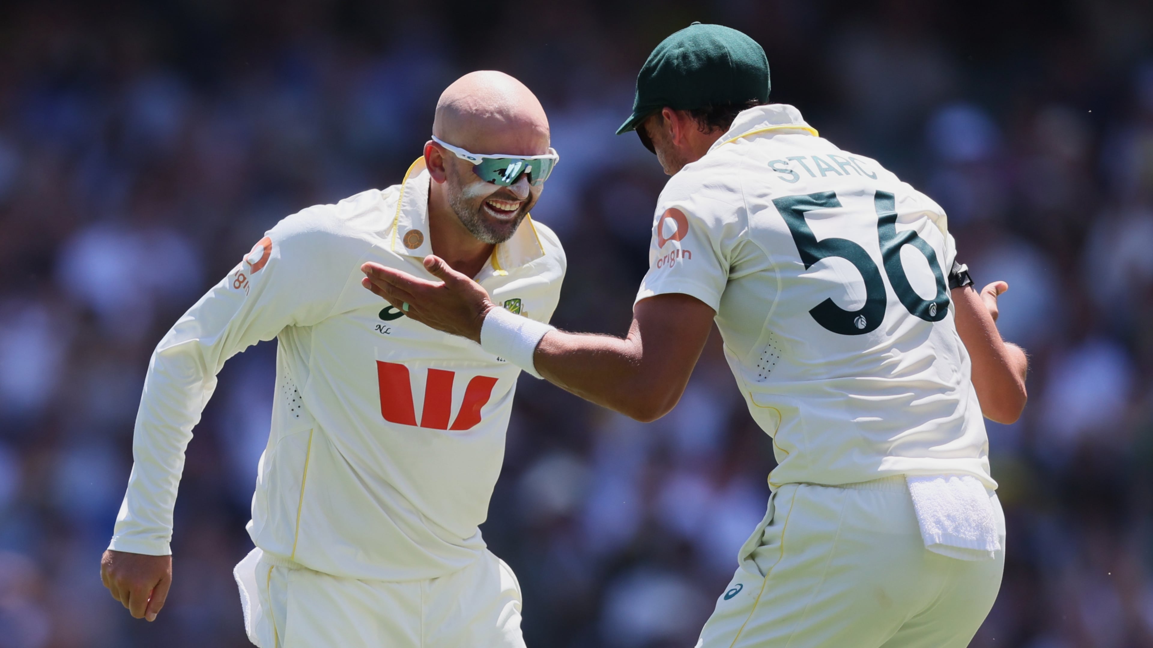 Australia's Nathan Lyon, left, celebrates with teammate Mitchell Starc after dismissing England's Ben Duckett during play on day two of the third Ashes cricket test between England and Australia in Adelaide, Australia, Thursday, Dec. 18, 2025. (AP Photo/James Elsby)