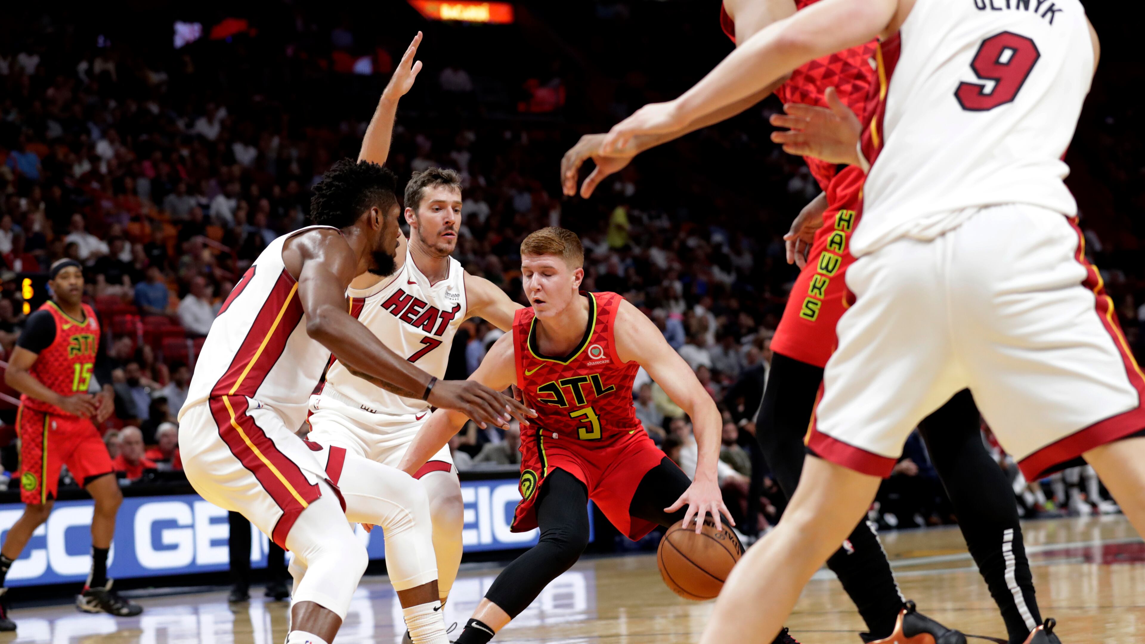 Atlanta Hawks guard Kevin Huerter (3) drives as Miami Heat forward Chris Silva, left, and guard Goran Dragic (7) defend during the first half of an NBA basketball game Tuesday, Oct. 29, 2019, in Miami. (AP Photo/Lynne Sladky)