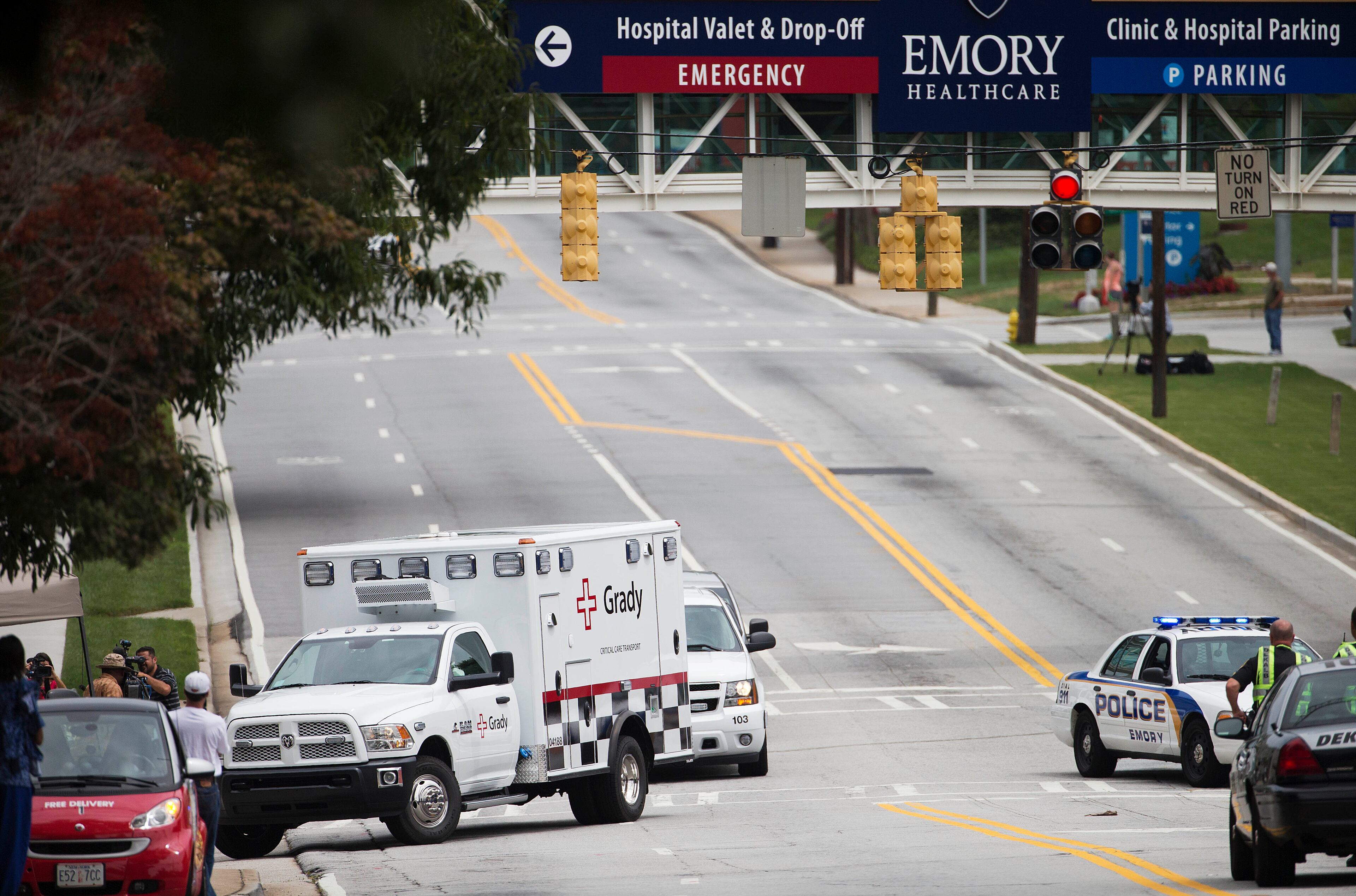 An ambulance arrives at Emory University Hospital transporting an American that was infected with the Ebola virus, Saturday, Aug. 2, 2014, in Atlanta. A specially outfitted plane carrying Dr. Kent Brantly from West Africa arrived at a military base in Georgia. Brantly was taken to the Atlanta hospital. Another American with Ebola is expected to join him at the hospital in a few days. (AP Photo/David Goldman)