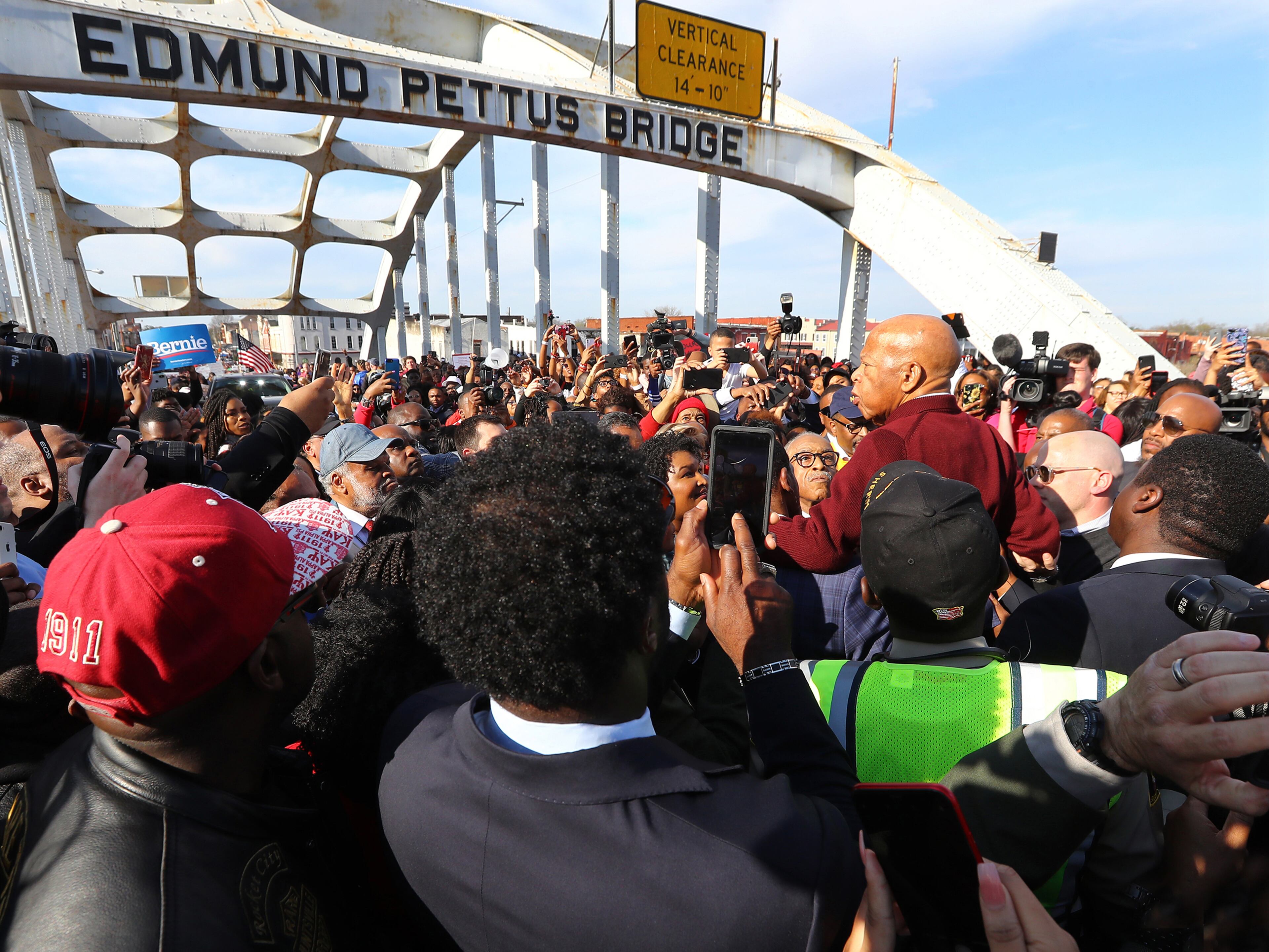 March 1, 2020 Selma: A group of men hoist U.S. Rep. John Lewis, D-Atlanta, on their shoulders so he can speak to the crowd of marchers at the Edmund Pettus Bridge during Selma's re-enactment of Bloody Sunday on Sunday, March 1, 2020, in Selma. Curtis Compton ccompton@ajc.com