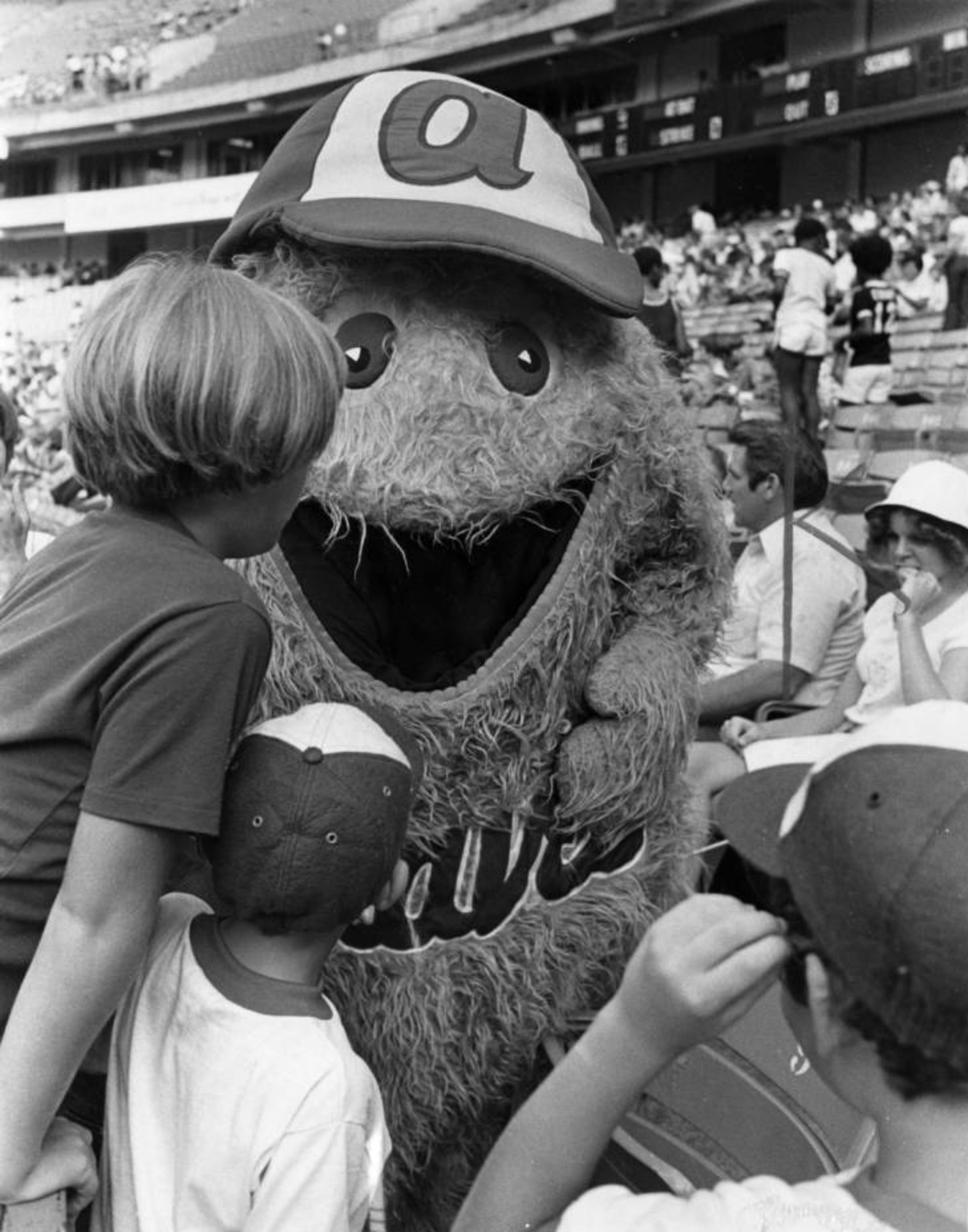 1978 -- Atlanta Braves mascot the Bleacher Creature interacts with young Braves' fans during a game. BUD SKINNER / AJC FILE