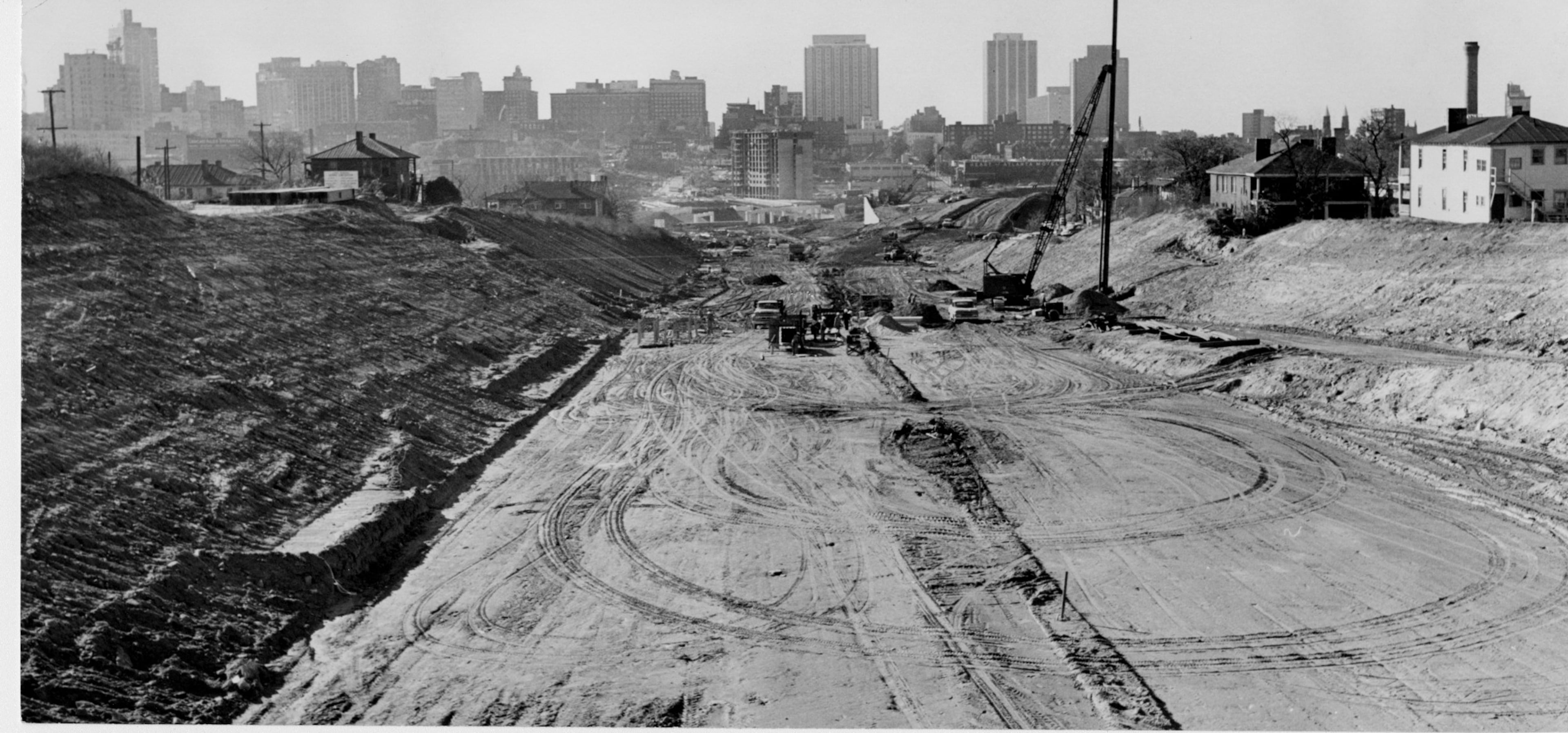 Nov. 1962 - Atlanta, Ga - Atlanta's skyline seems to offer a huge roadblock to highway construction in the foreground...From Boulevard, looking west, East Expressway (I-20) road construction aims for the heart of the city, but turns right in the distance.