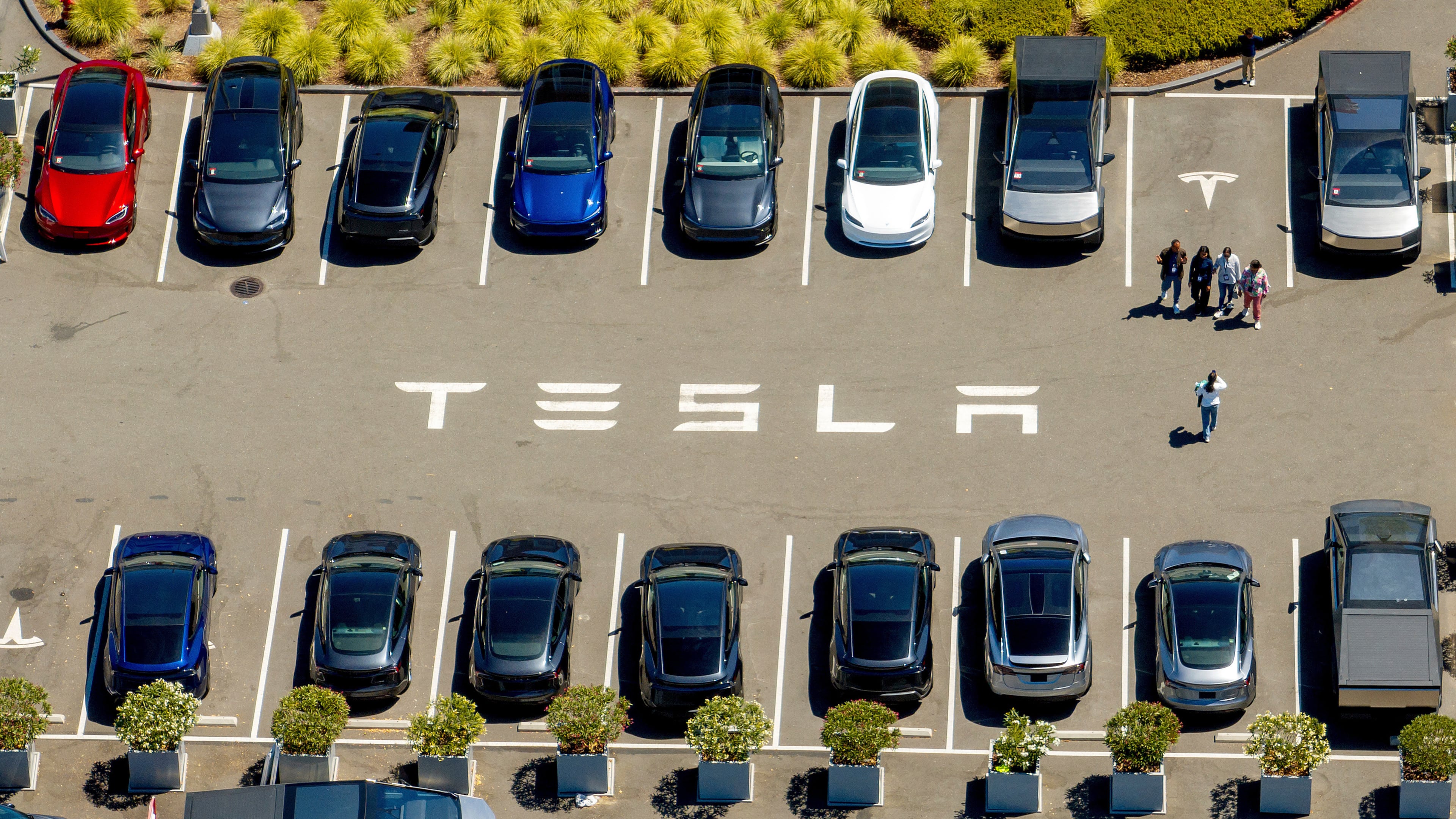 FILE - Tesla vehicles line a parking lot at the company's Fremont, Calif., factory on Aug. 5, 2025. (AP Photo/Noah Berger, File)